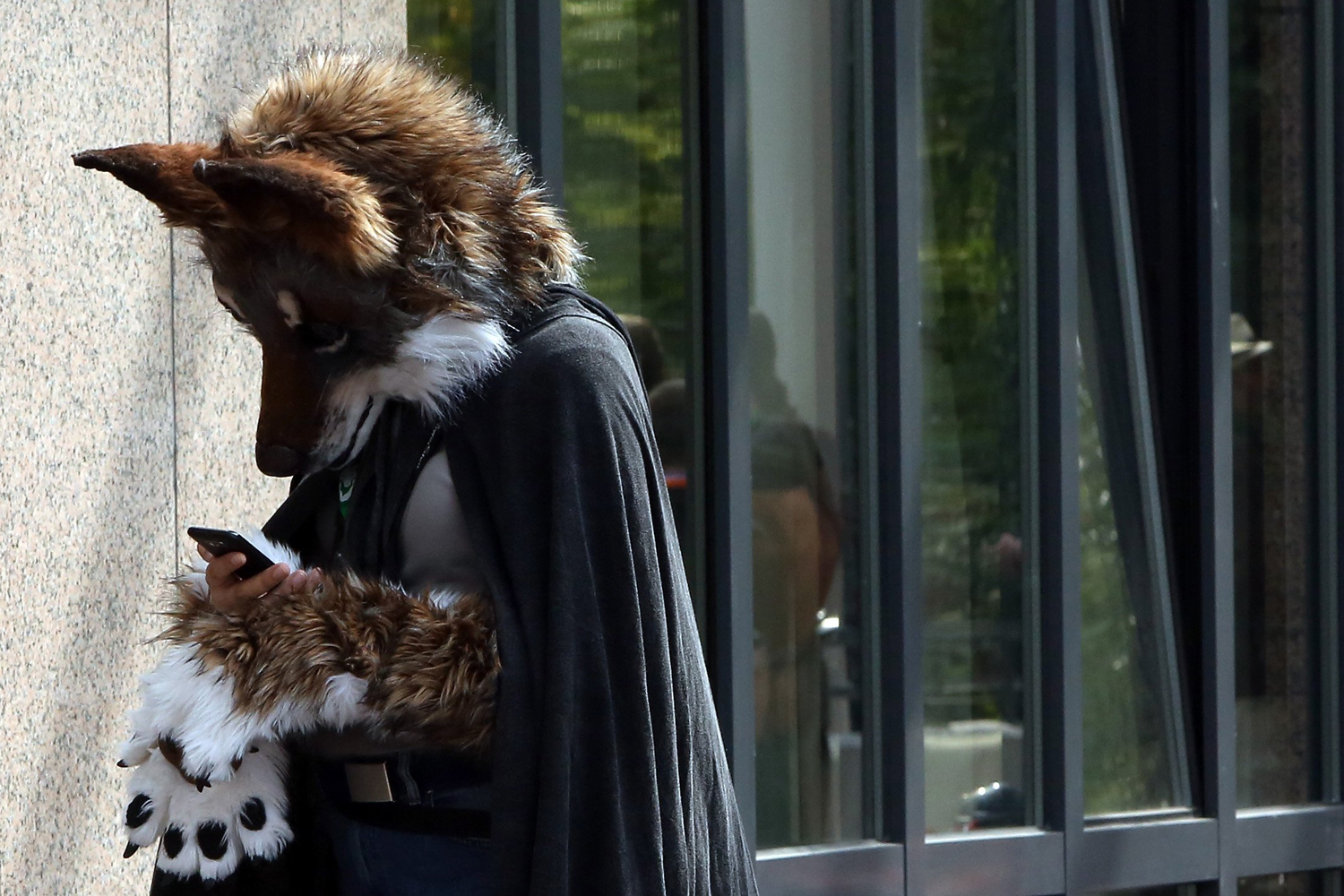 A Furry enthusiast uses a mobile phone as he attends the Eurofurence 2014 conference in Berlin on Aug. 22, 2014.