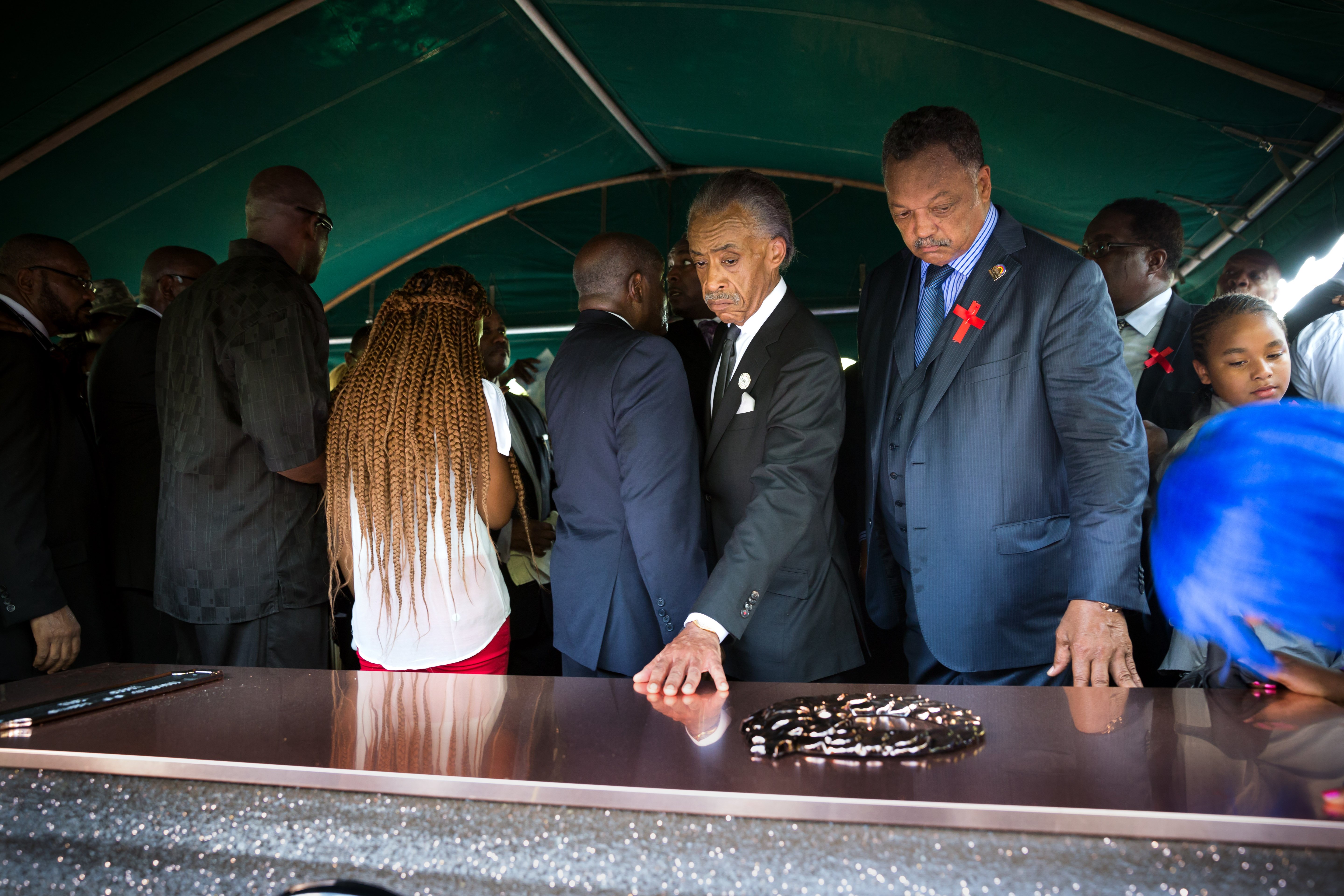 Rev. Al Sharpton and Jessie Jackson touch the casket during the funeral for Michael Brown at St. Peters Cemetery in St. Louis on Aug. 25, 2014.