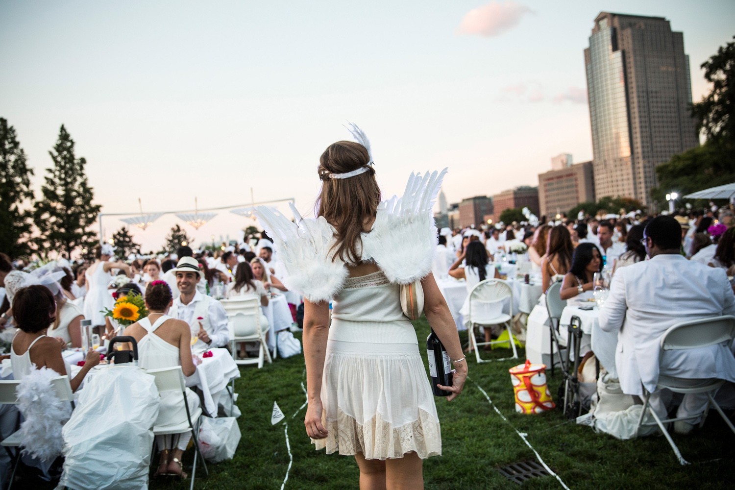A woman wearing wings attends Diner en Blanc (French for Dinner in White), a pop-up dinner held once a year in New York City on Aug. 25, 2014.