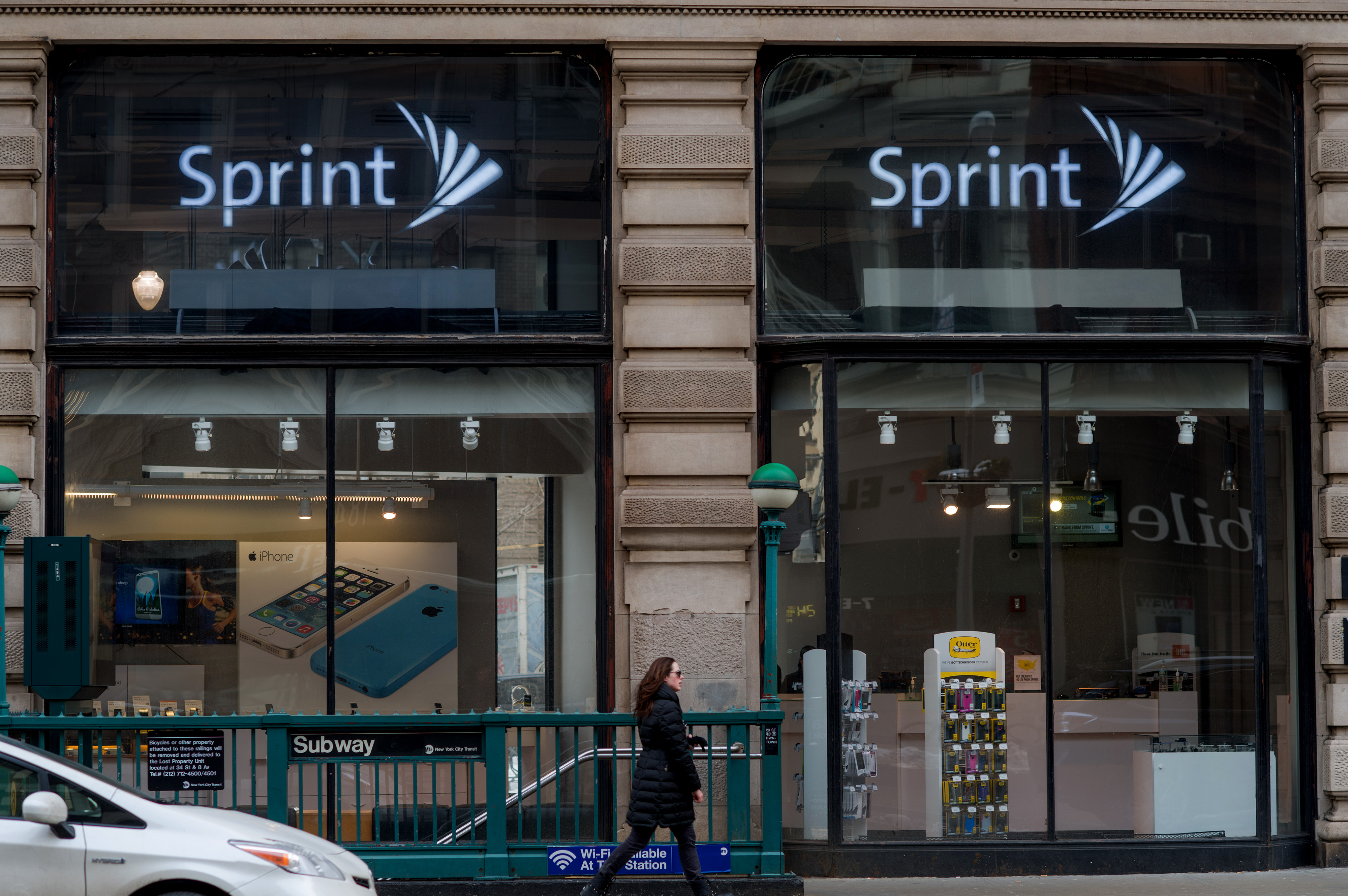 A pedestrian passes in front of a Sprint store in New York City on Saturday, Feb. 8, 2014. (Bloomberg—Bloomberg via Getty Images)