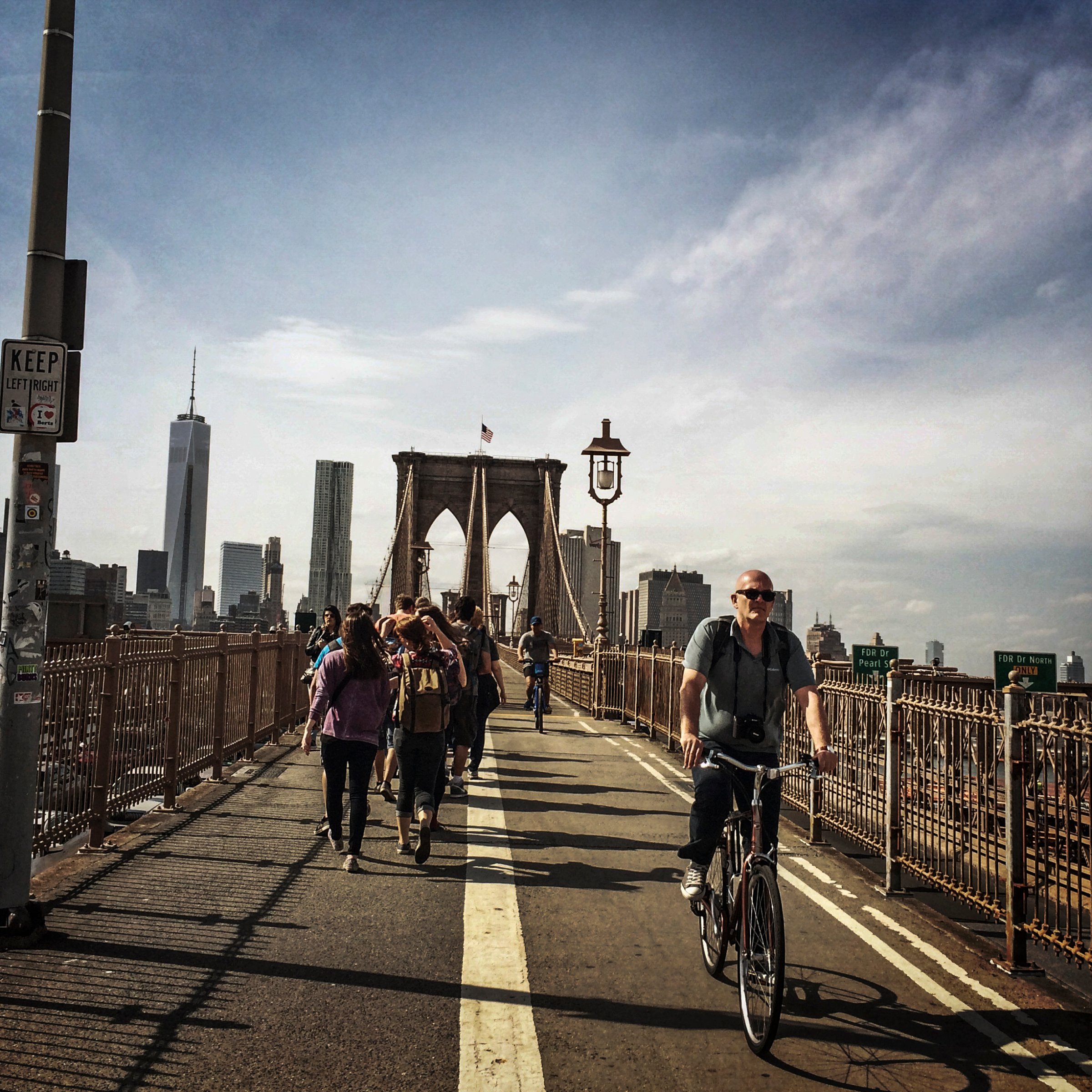People walk and ride bikes across the Brooklyn Bridge in April 2014.