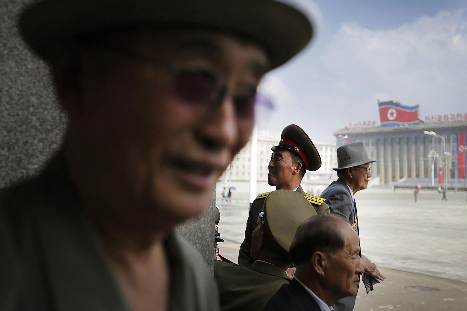 Men wait for the start of a parade, to celebrate the 61st anniversary of the Korean War armistice, at Kim Il Sung Square  in Pyongyang, Jul. 27, 2014.