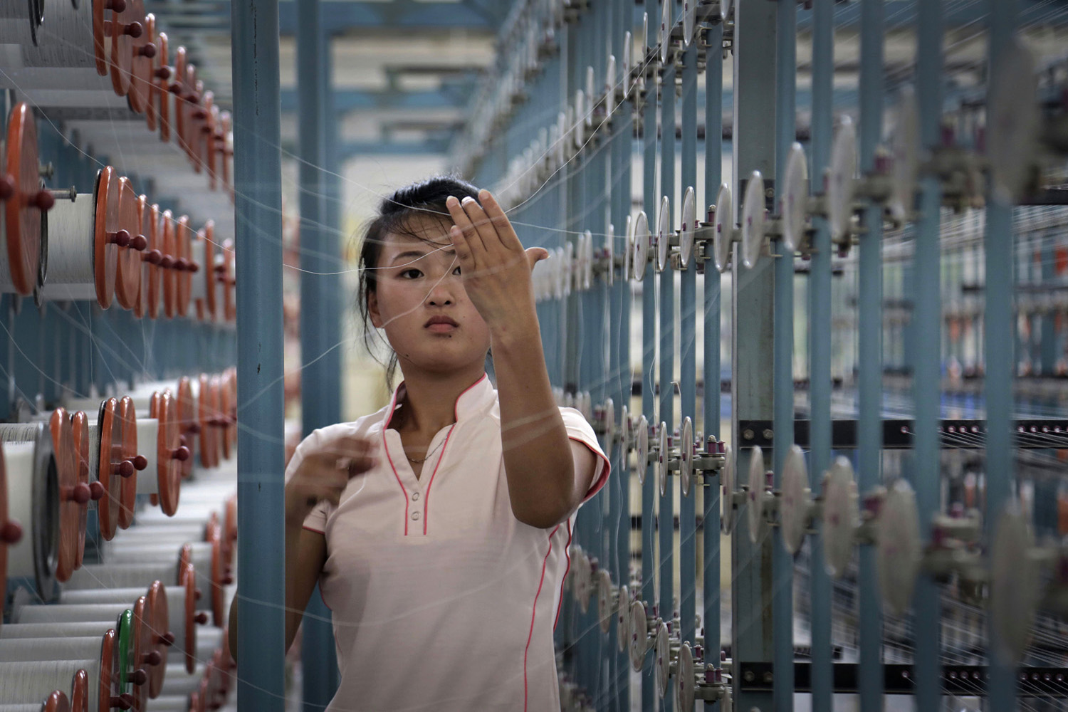 A woman works at the Kim Jong Suk textile factory, the country's largest with 8,500 workers, in Pyongyang, Jul. 31, 2014.