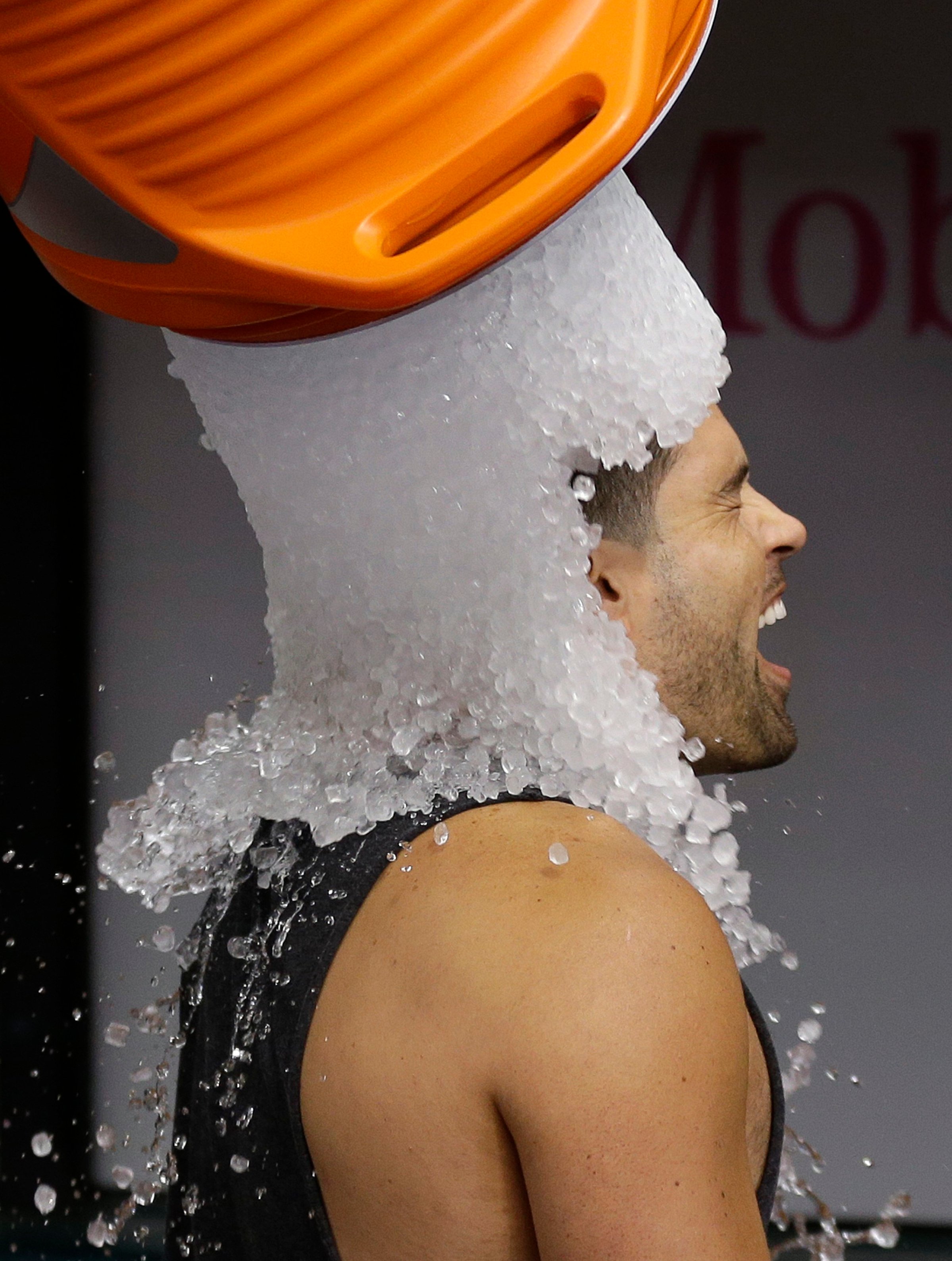Tampa Bay Rays' David DeJesus gets a bucket of ice dumped on his head from video coordinator Chris Fernandez as part of the ALS Ice Bucket Challenge before a baseball game against the New York Yankees on Aug. 17, 2014, in St. Petersburg, Fla.