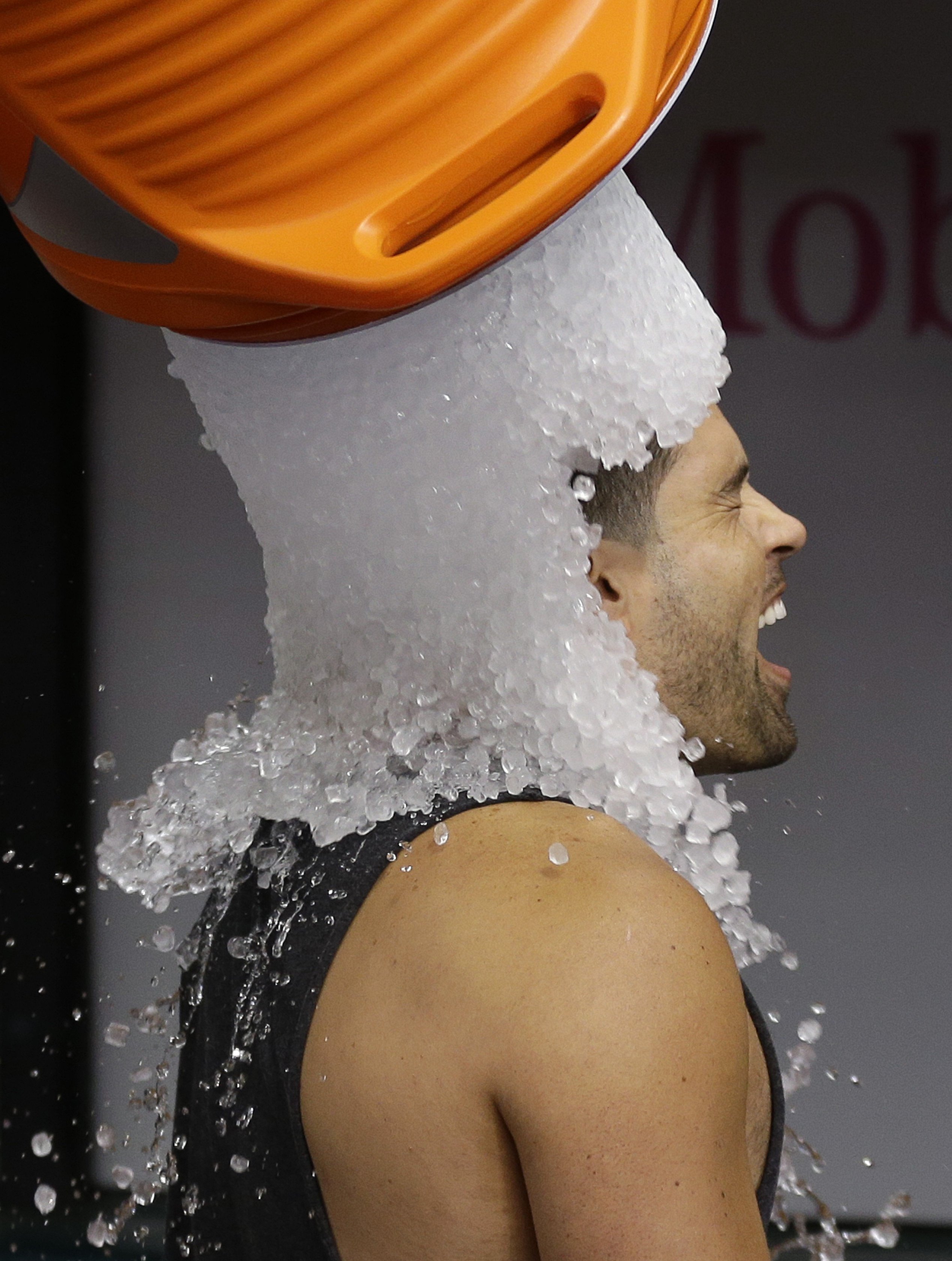 Tampa Bay Rays' David DeJesus gets a bucket of ice dumped on his head from video coordinator Chris Fernandez as part of the ALS Ice Bucket Challenge before a baseball game against the New York Yankees on Aug. 17, 2014, in St. Petersburg, Fla. (Chris O&#039;Meara—AP)