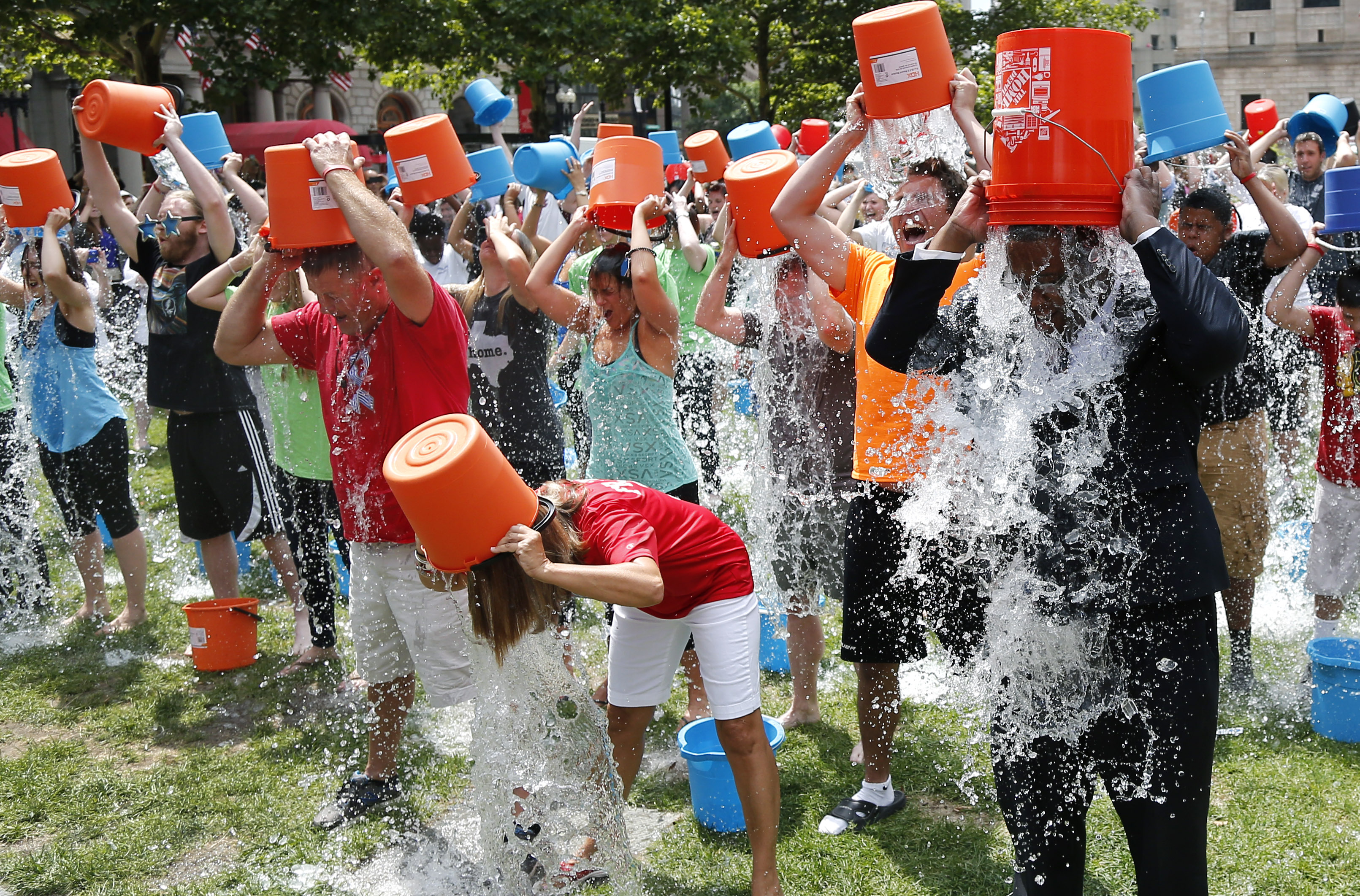 Boston City Councillor Tito Jackson, right, leads some 200 people in the ice bucket challenge at Boston's Copley Square, Thursday, Aug. 7, 2014 to raise funds and awareness for ALS. (Elise Amendola—AP)