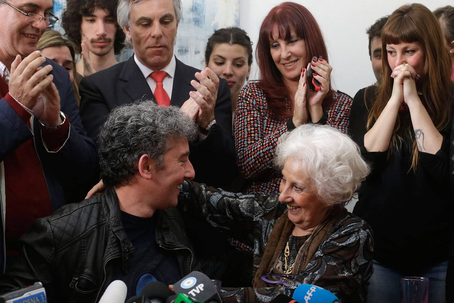 Estela de Carlotto, president of Grandmothers of Plaza de Mayo, right, and her grandson Ignacio Hurban, left, hug during a news conference in Buenos Aires, Aug. 8, 2014. (Victor R. Caivano—AP)