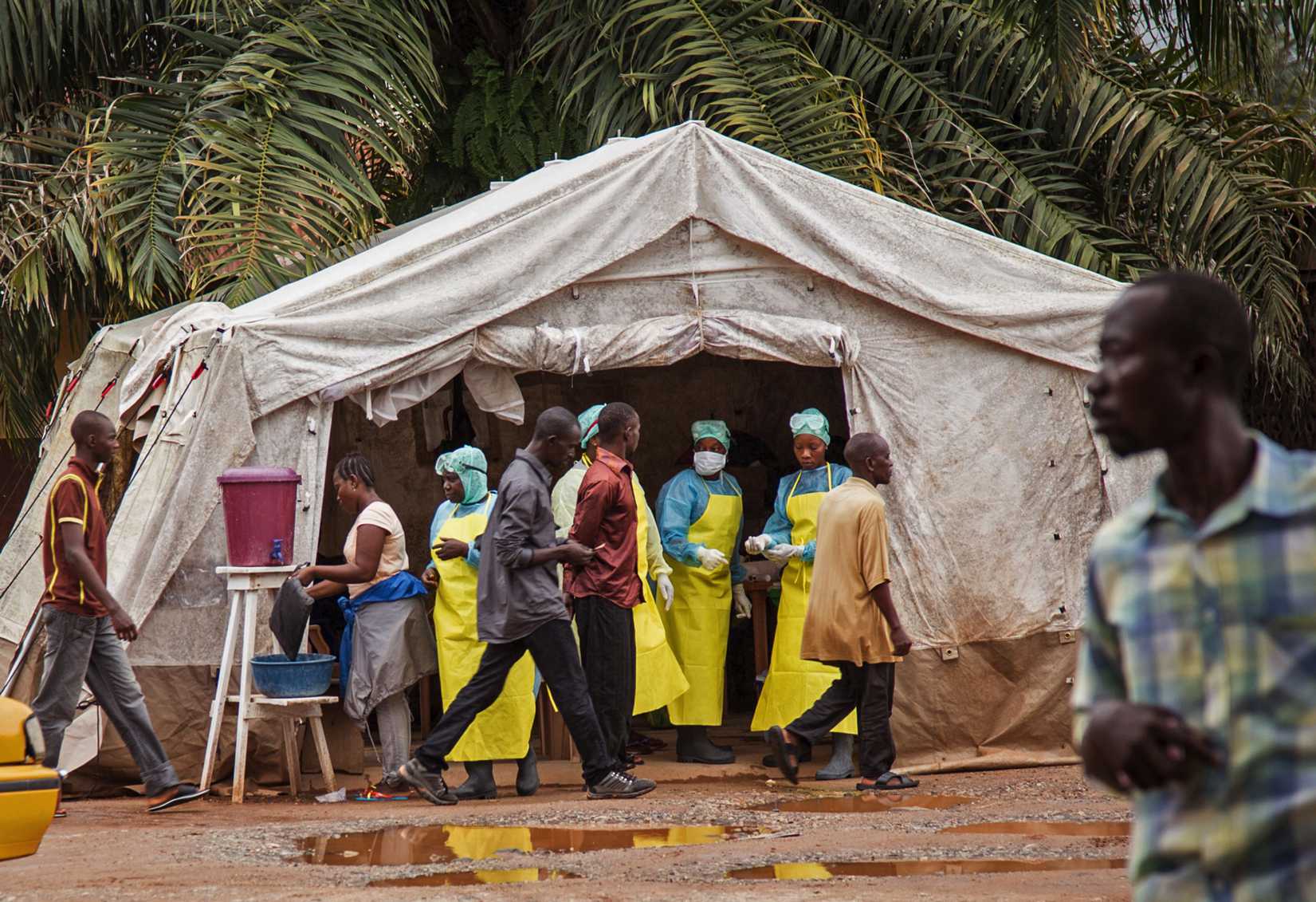 Health workers screen people for the deadly Ebola virus before entering the Kenema Government Hospital in Kenema, 300 kilometers, (186 miles) from the capital city of Freetown, Sierra Leone on August 9, 2014.