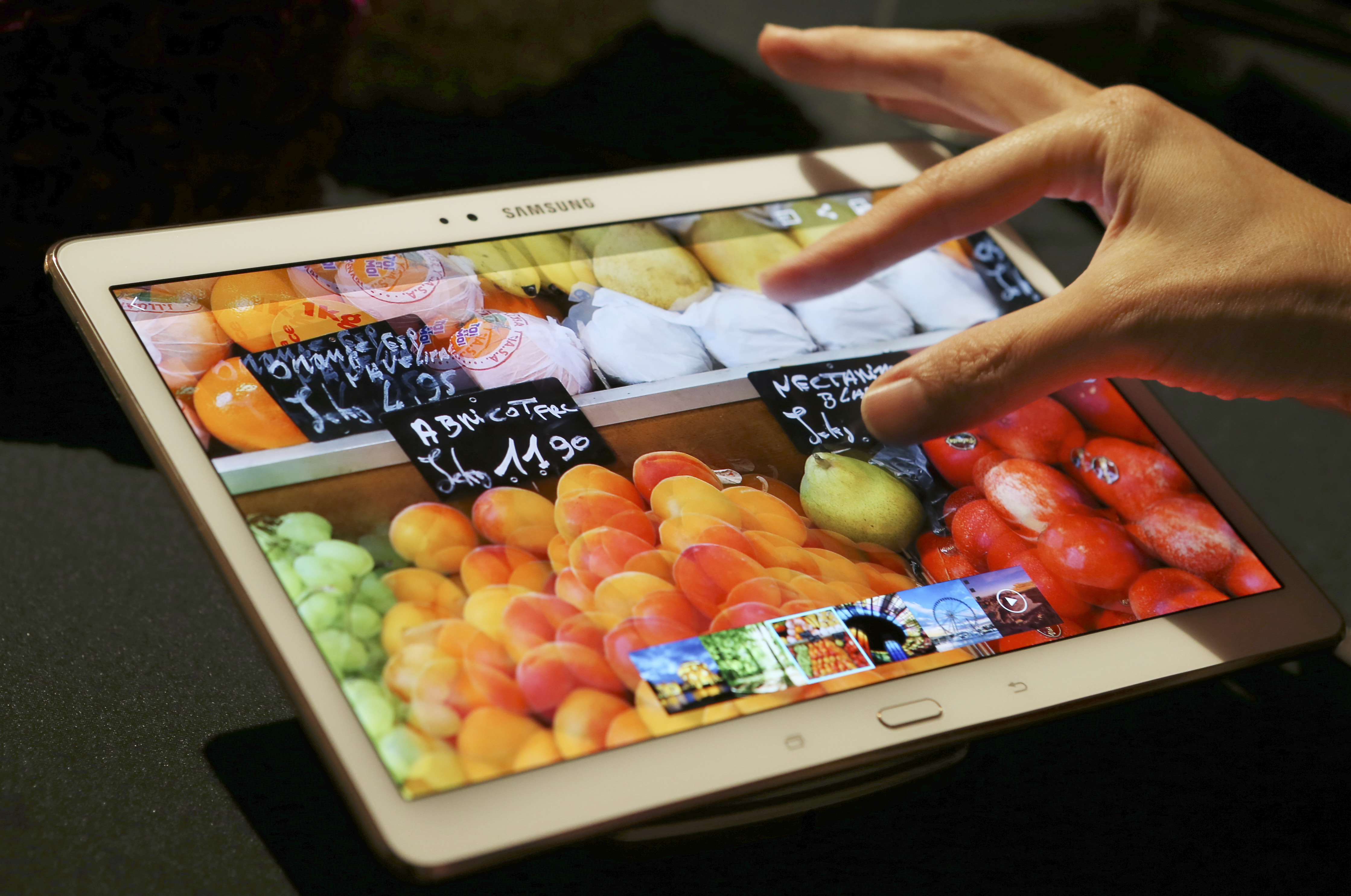 A visitor tries out Samsung Electronics Co.'s 10.5-inch Galaxy Tab S tablet during an event in Tokyo, Japan on July 31, 2014.