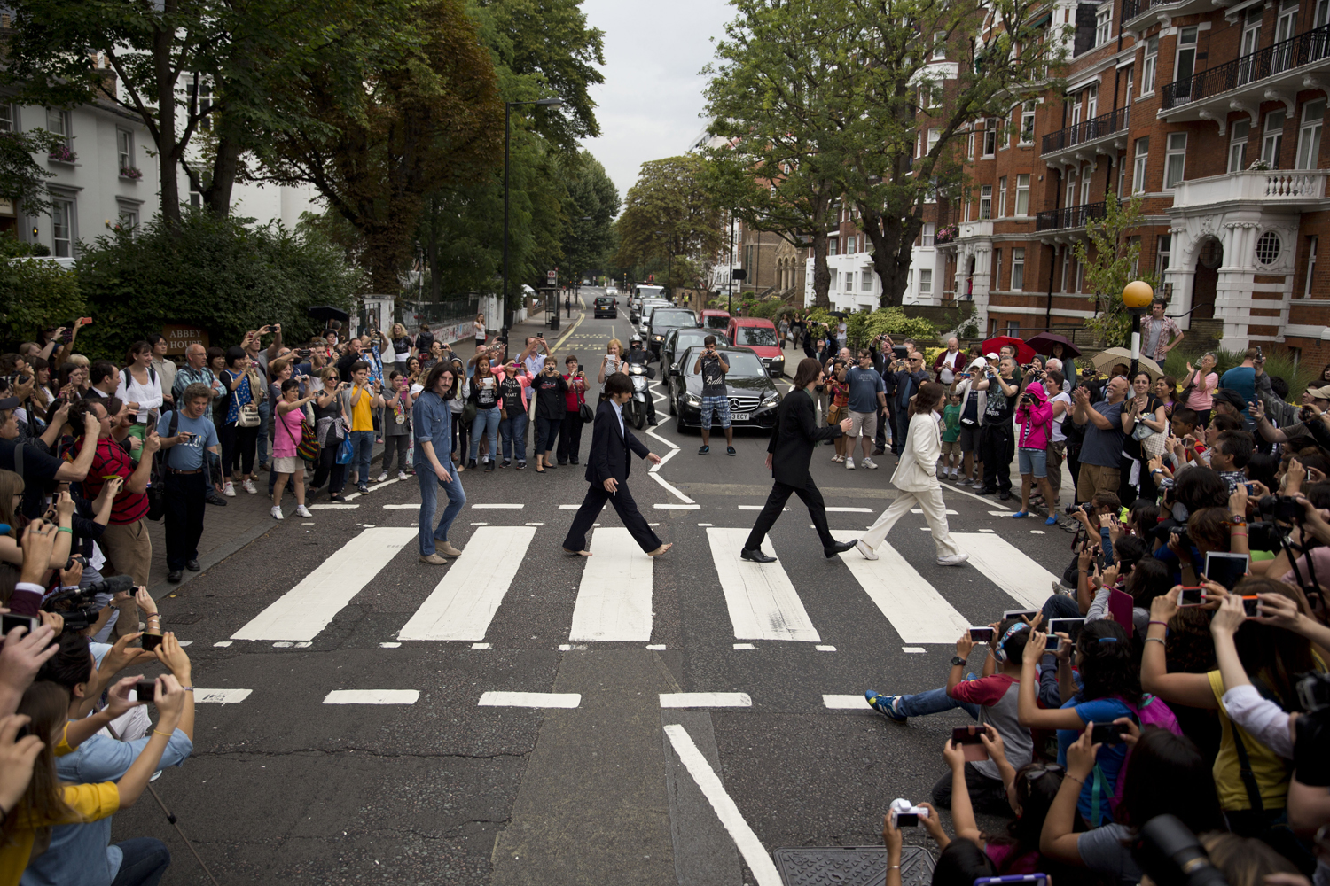 Aug. 8, 2014. The cast of the West End Beatles musical show  Let it Be  pose for photographers by attempting to recreate the cover photograph of the Beatles album  Abbey Road  on the zebra crossing on Abbey Road in London.