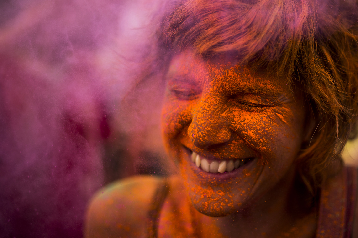 Aug. 9, 2014. A reveler is covered in coloured powder,  during a Monsoon Holi Festival in Madrid, Spain.