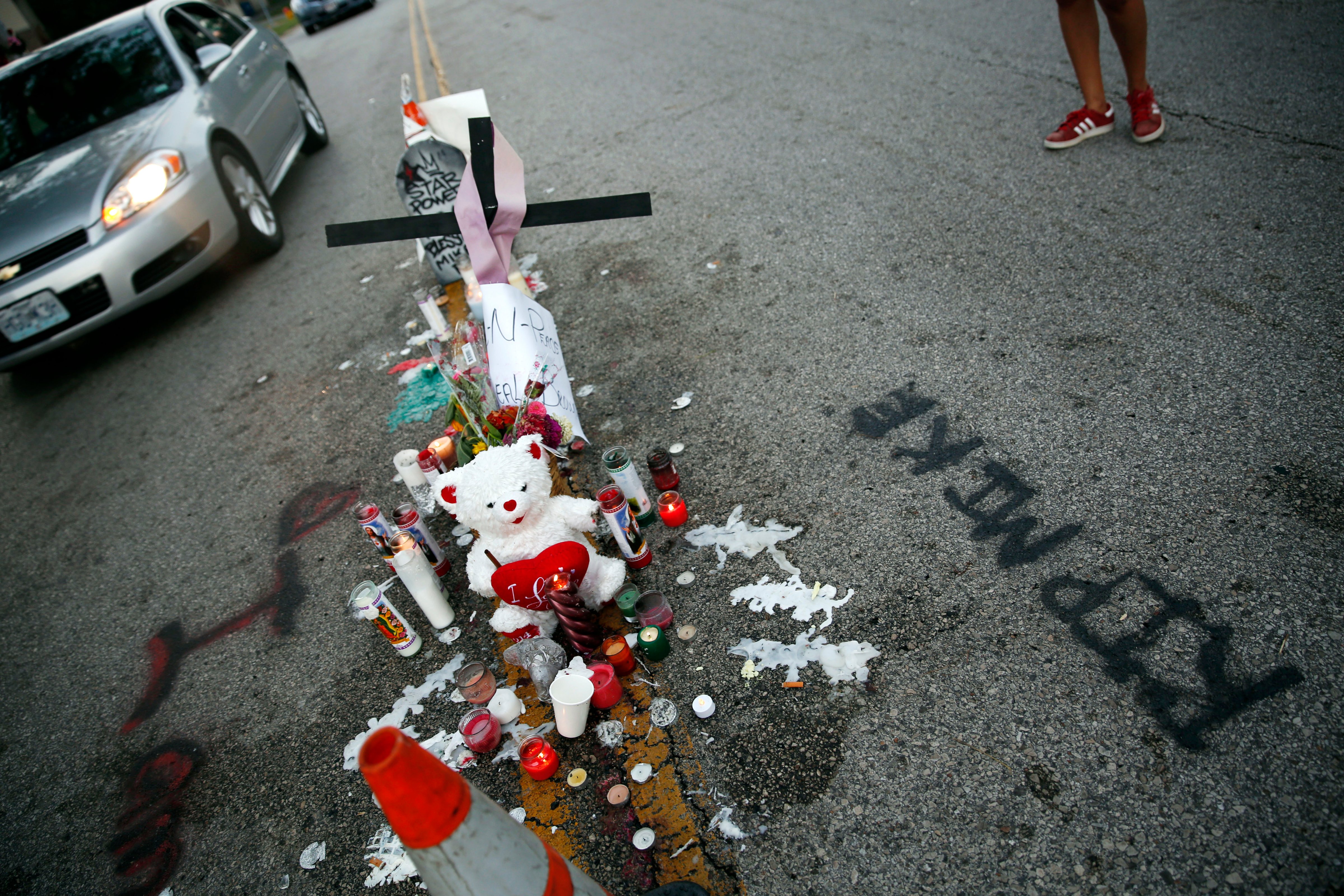 A makeshift memorial sits in the middle of the street where 18-year-old Michael Brown was shot and killed by police (Jeff Roberson&mdash;AP)