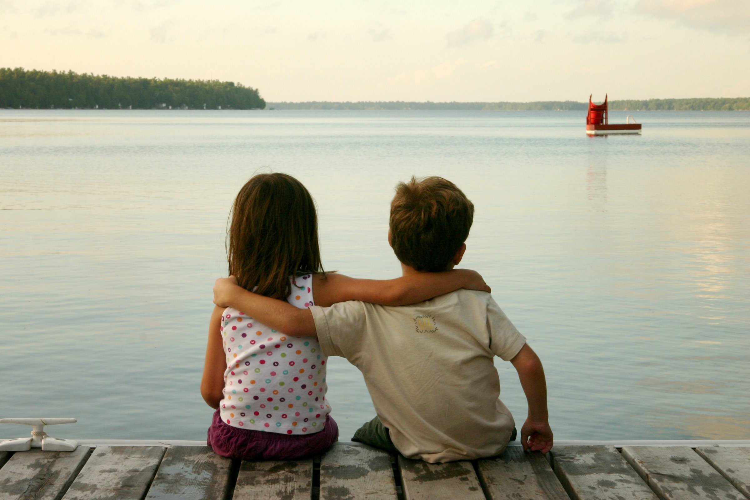 boy-and-girl-sitting-by-lake