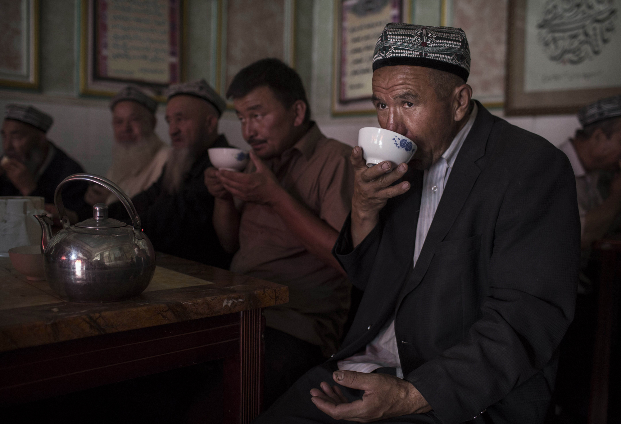 A Uyghur man drinks tea at a restaurant on August 1, 2014 in old Kashgar.