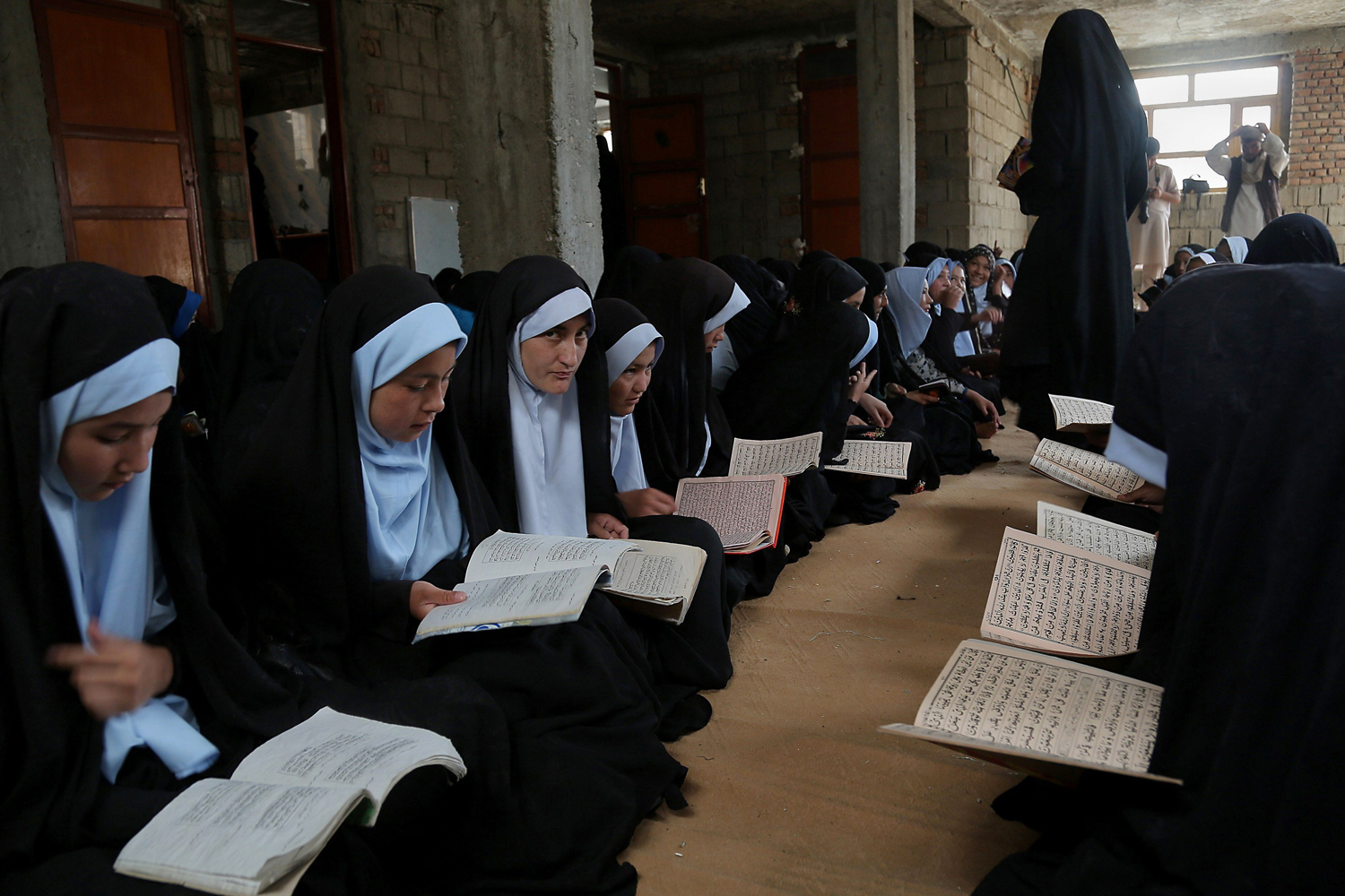 Aug. 26, 2014. Afghan students read and memorize the holy Quran at a madrassa (religious school) in Ghazni.