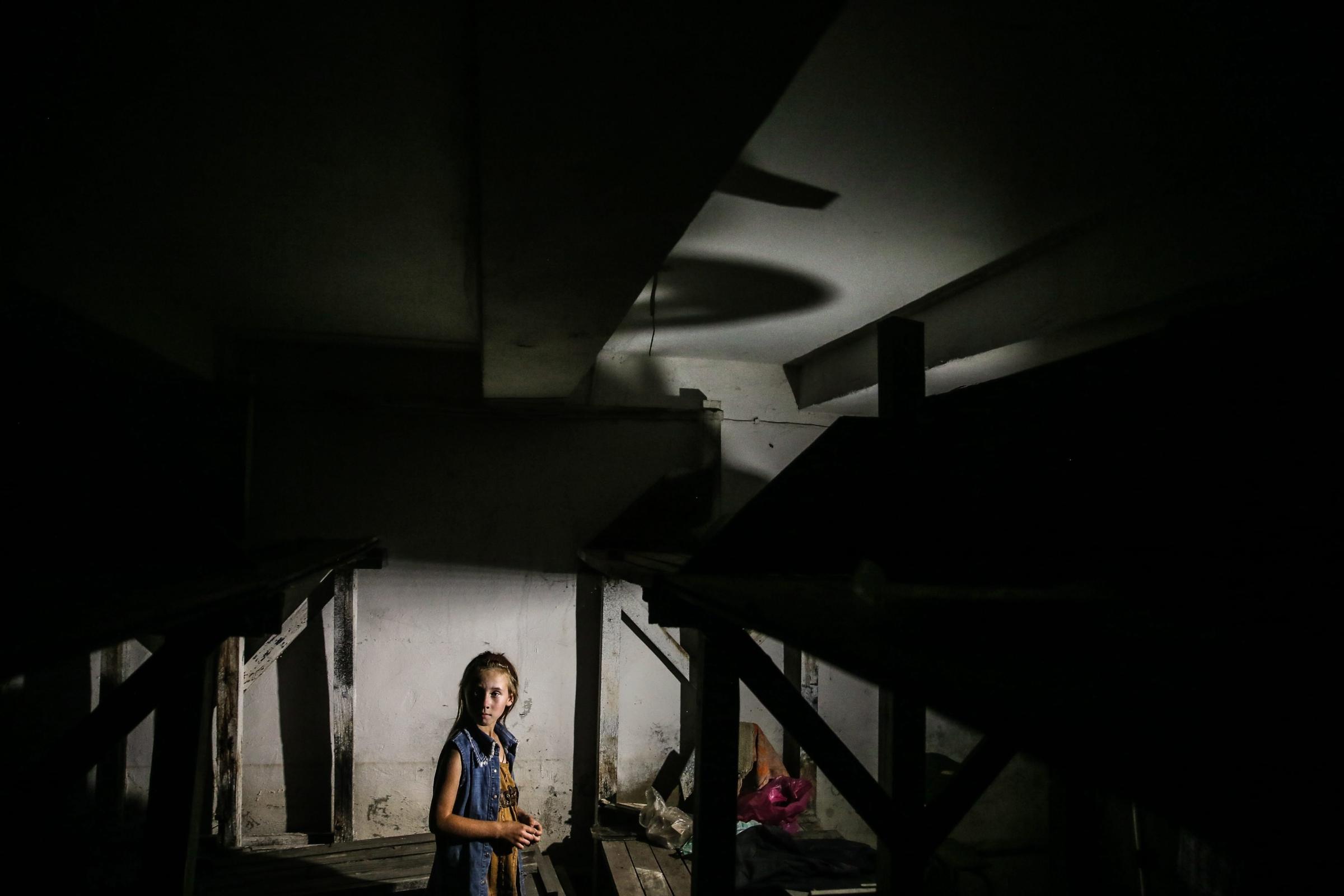 Crisis in UkraTatiana, 9, stands in a shelter in Ilovaysk, some 50km from Donetsk, eastern Ukraine on August 14, 2014. ine
