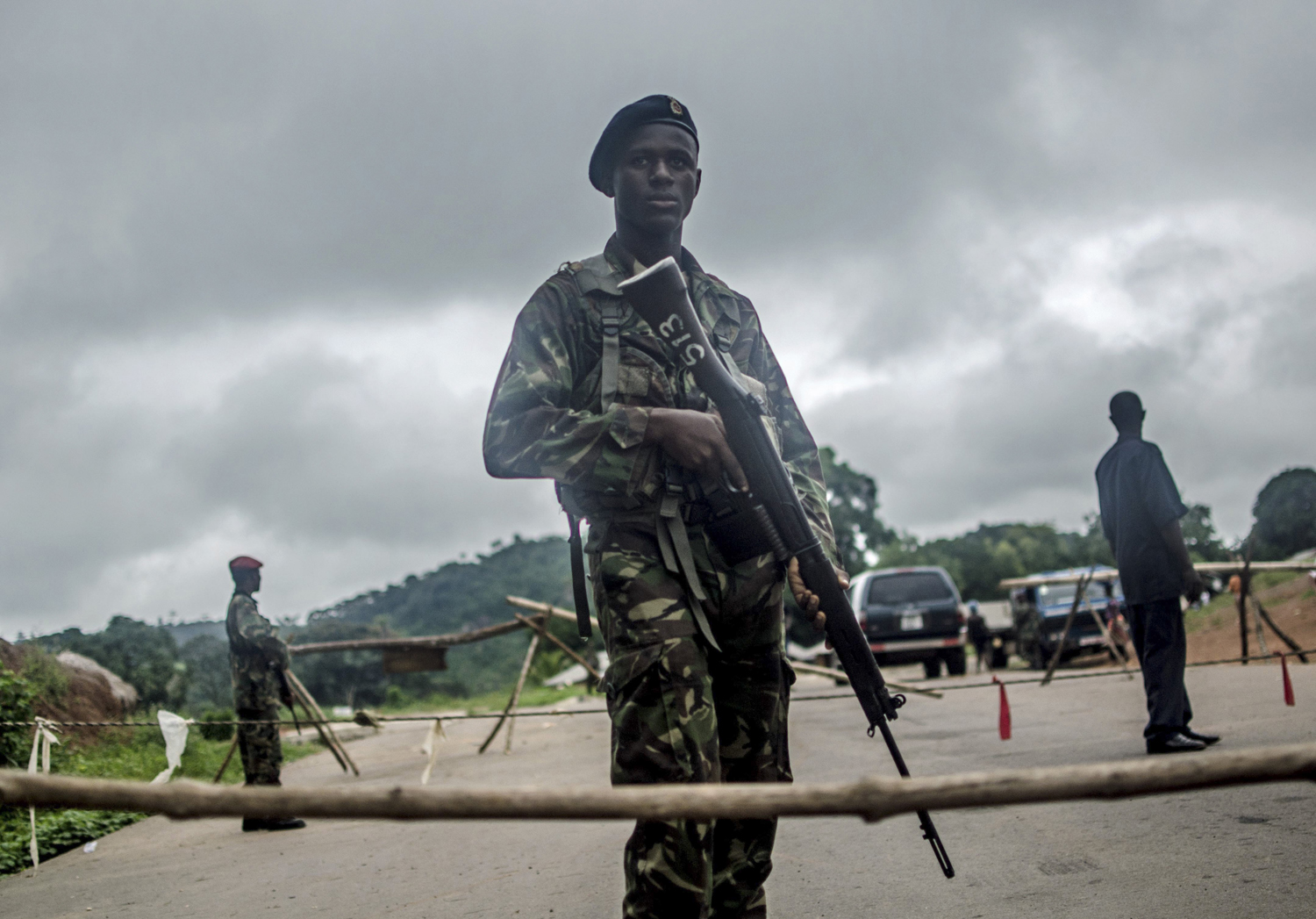 Aug. 8, 2014. Soldiers stand guard at a roadblock outside Kenema, Sierra Leone.