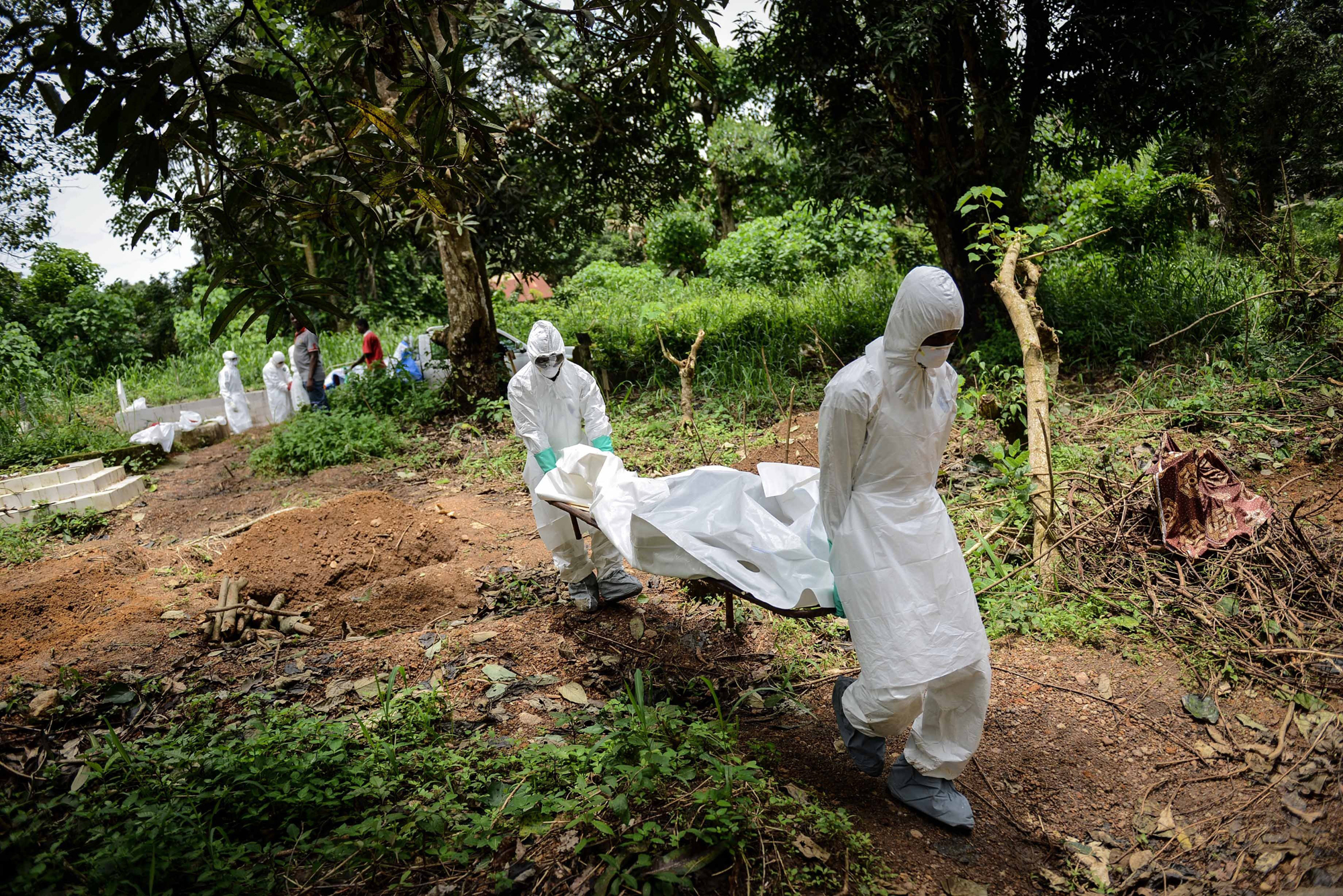 A group of young volunteers wear special uniforms for the burial of Ebola victims in Kenema, Sierra Leone on Aug. 24, 2014. (Mohammed Elshamy—Anadolu Agency/Getty Images)
