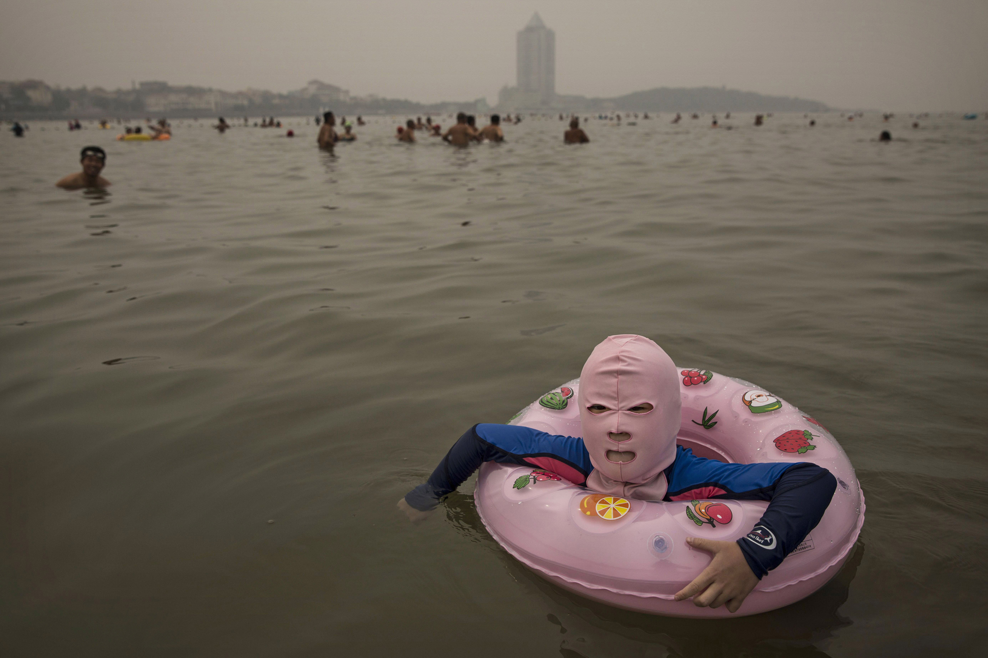 A Chinese girl wears a face-kini as she floats in the water on August 21, 2014 on the Yellow Sea in Qingdao.