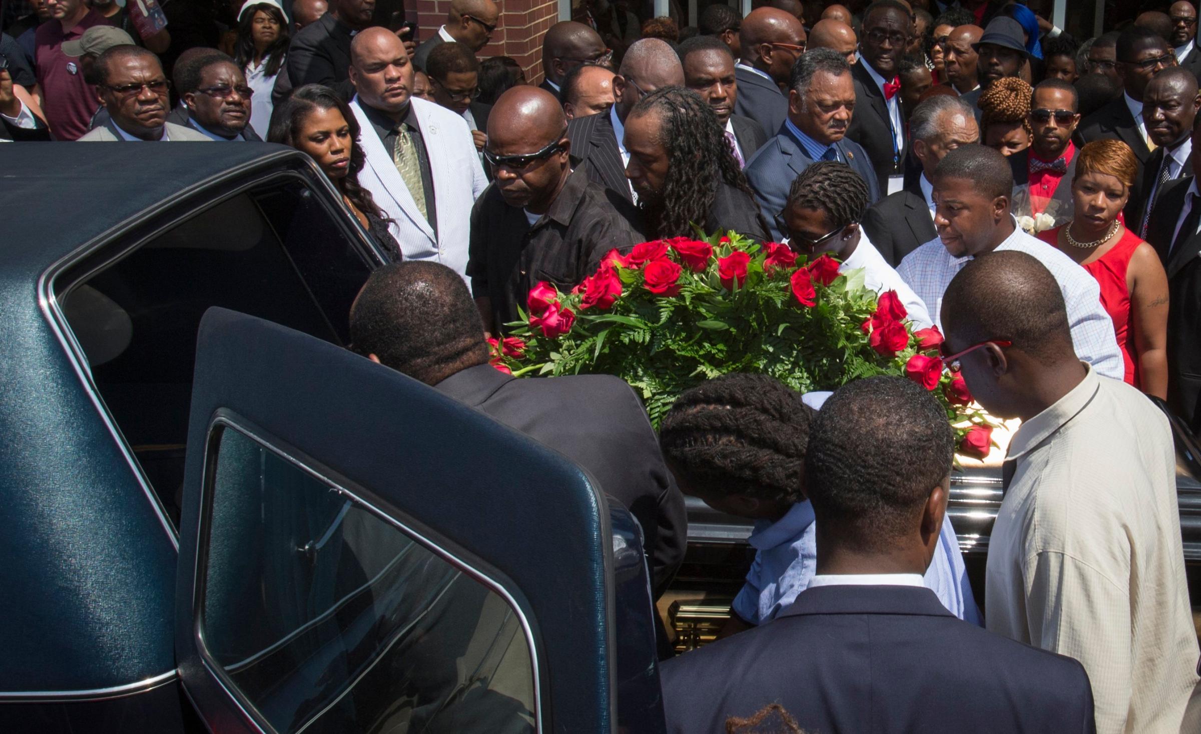 Lesley McSpadden watches as the casket containing the body of her son Michael Brown lifted into a hearse after his funeral services at Friendly Temple Missionary Baptist Church, St. Louis, Missouri