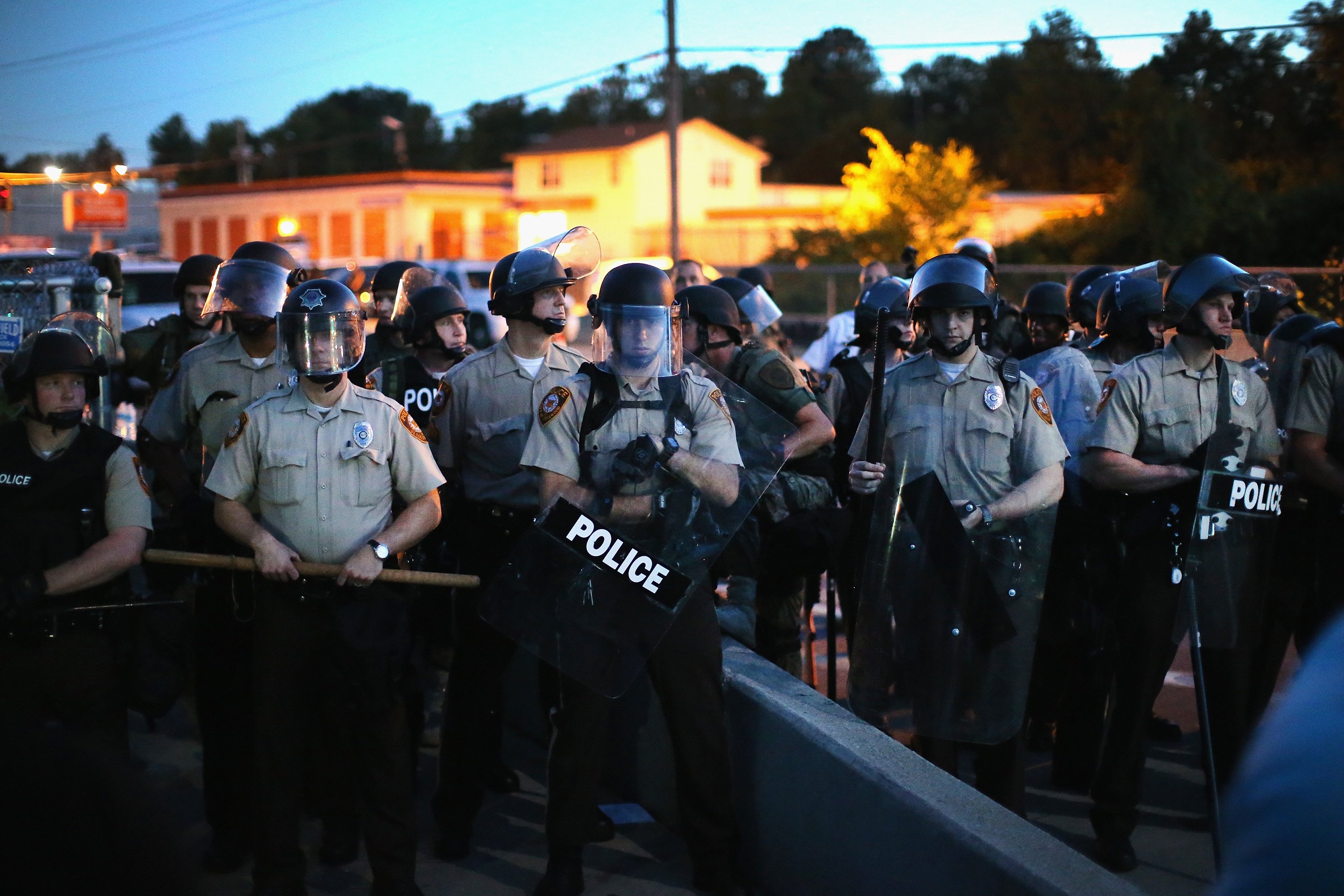 Police stand watch as demonstrators protest the shooting death of teenager Michael Brown in Ferguson, Mo. on Aug. 13, 2014. (Scott Olson—Getty Images)