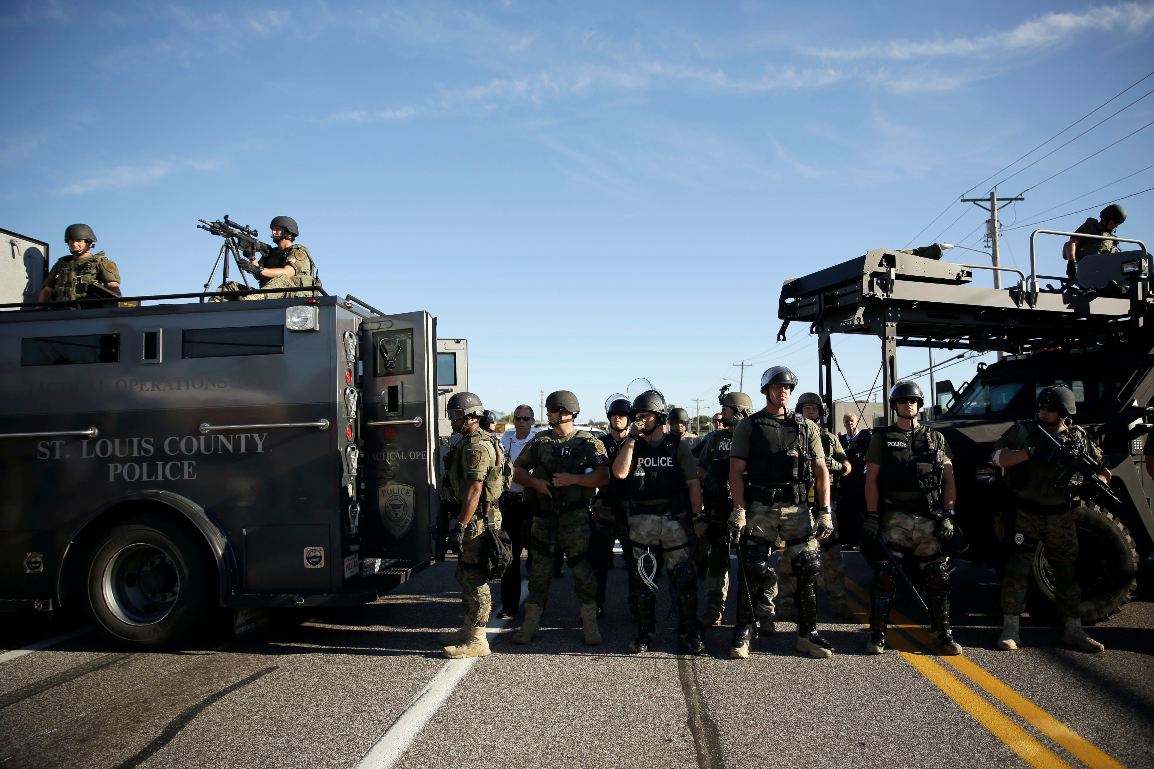 Police in riot gear watch protesters in Ferguson, Mo. on Aug. 13, 2014. (Jeff Roberson—AP)
