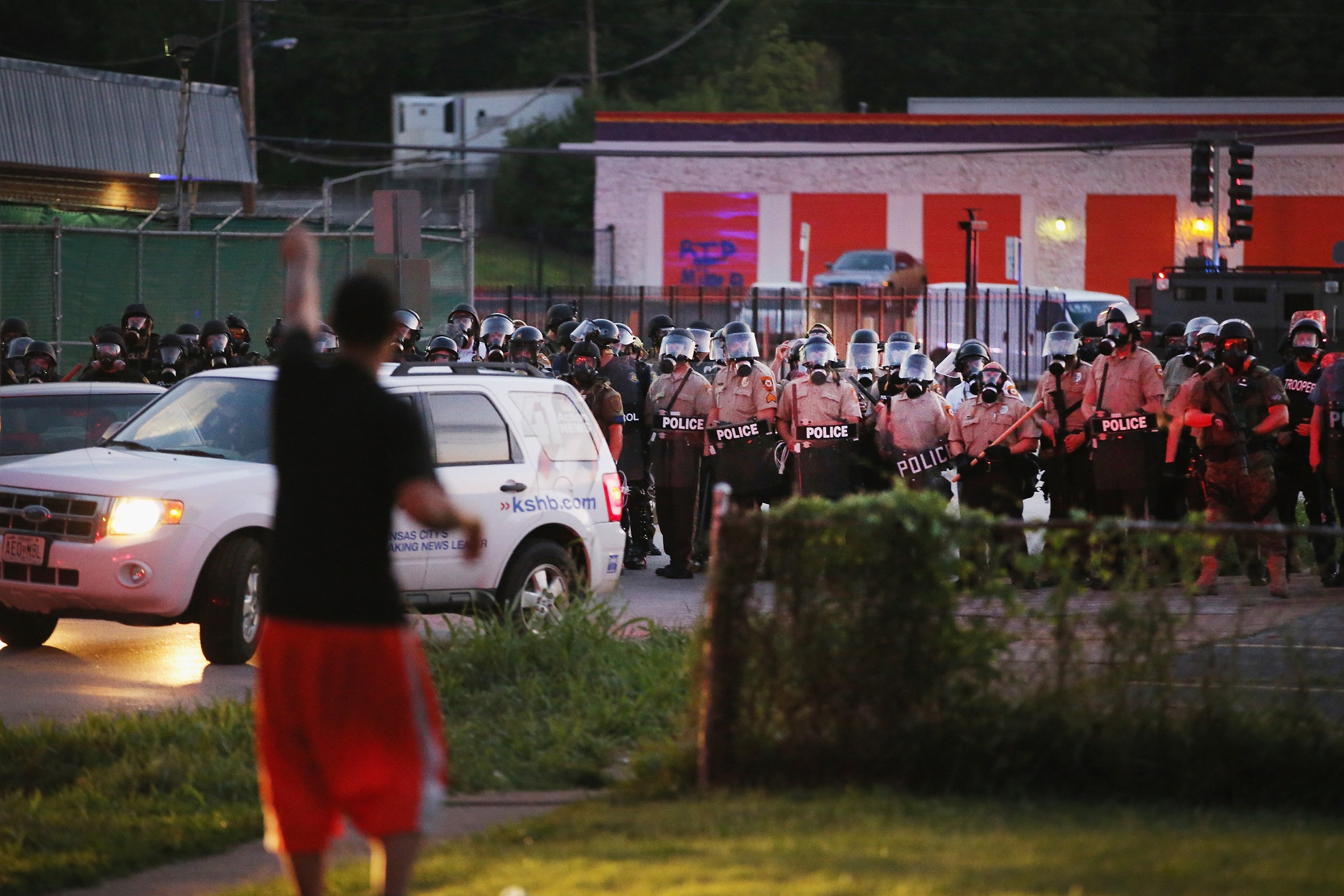 Riot police force protestors from the business district into nearby neighborhoods in Ferguson, Mo. on Aug. 11, 2014.