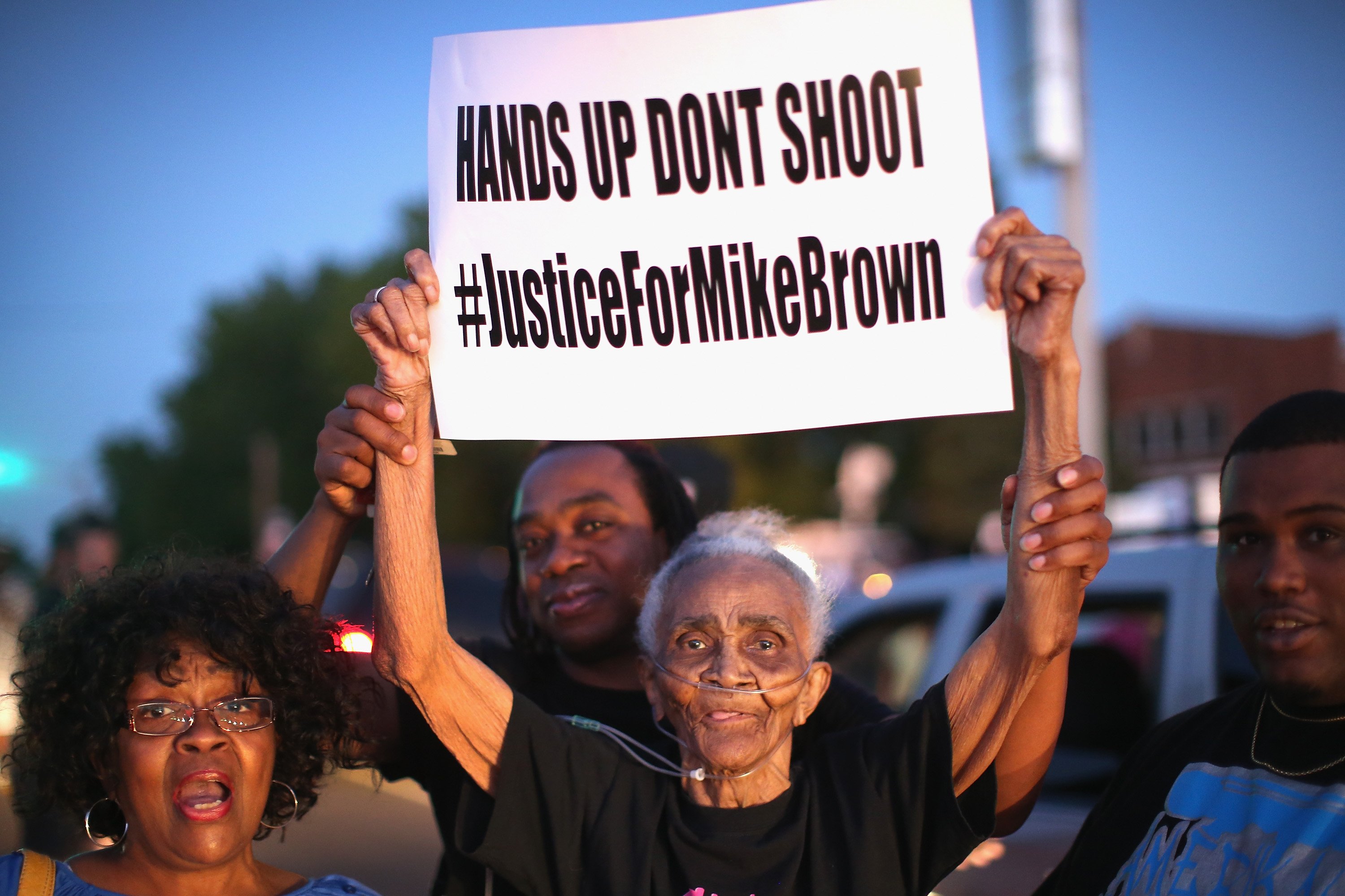 Eighty-eight-year-old Creola McCalister joins other demonstrators protesting the killing of teenager Michael Brown outside Greater St. Marks Family Church with Brown's family and with civil rights leader Rev. Al Sharpton in St. Louis on  Aug. 12, 2014. (Scott Olson—Getty Images)