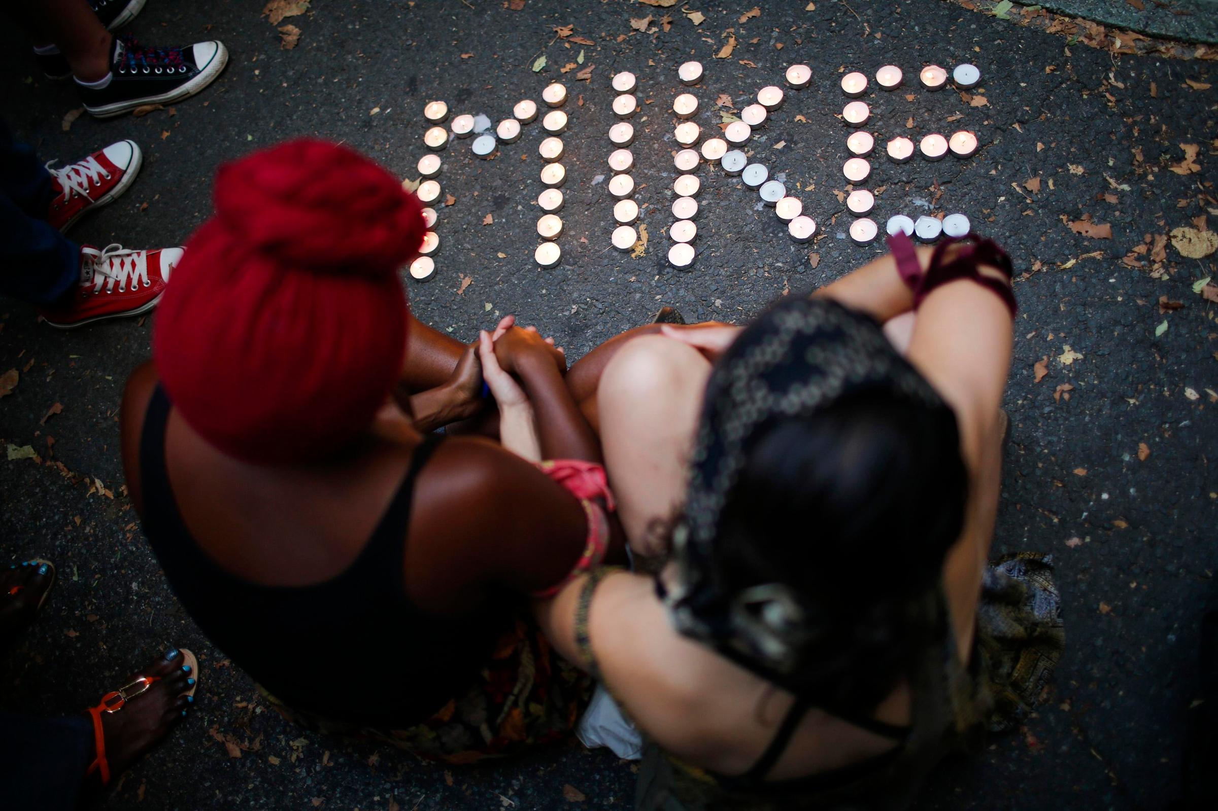 People attend a vigil to honor Michael Brown in Brooklyn