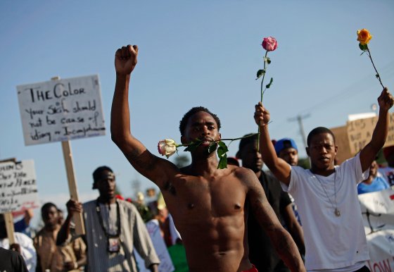 Demonstrators protest against the fatal shooting of Michael Brown in Ferguson, Mo. Aug. 19, 2014.