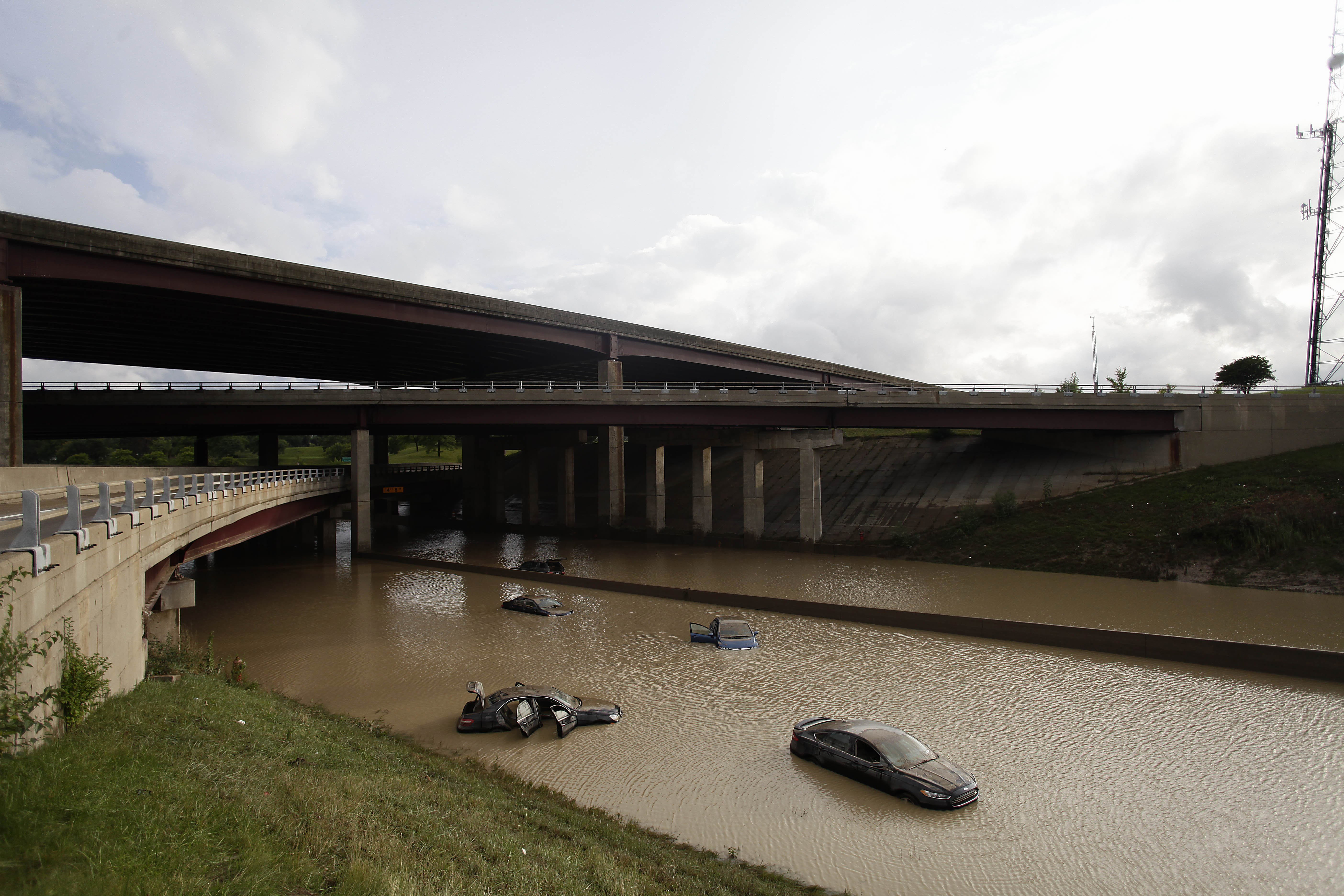 Aug. 12, 2014. Vehicles sit submerged in water along I-75, in Royal Oak, Michigan.