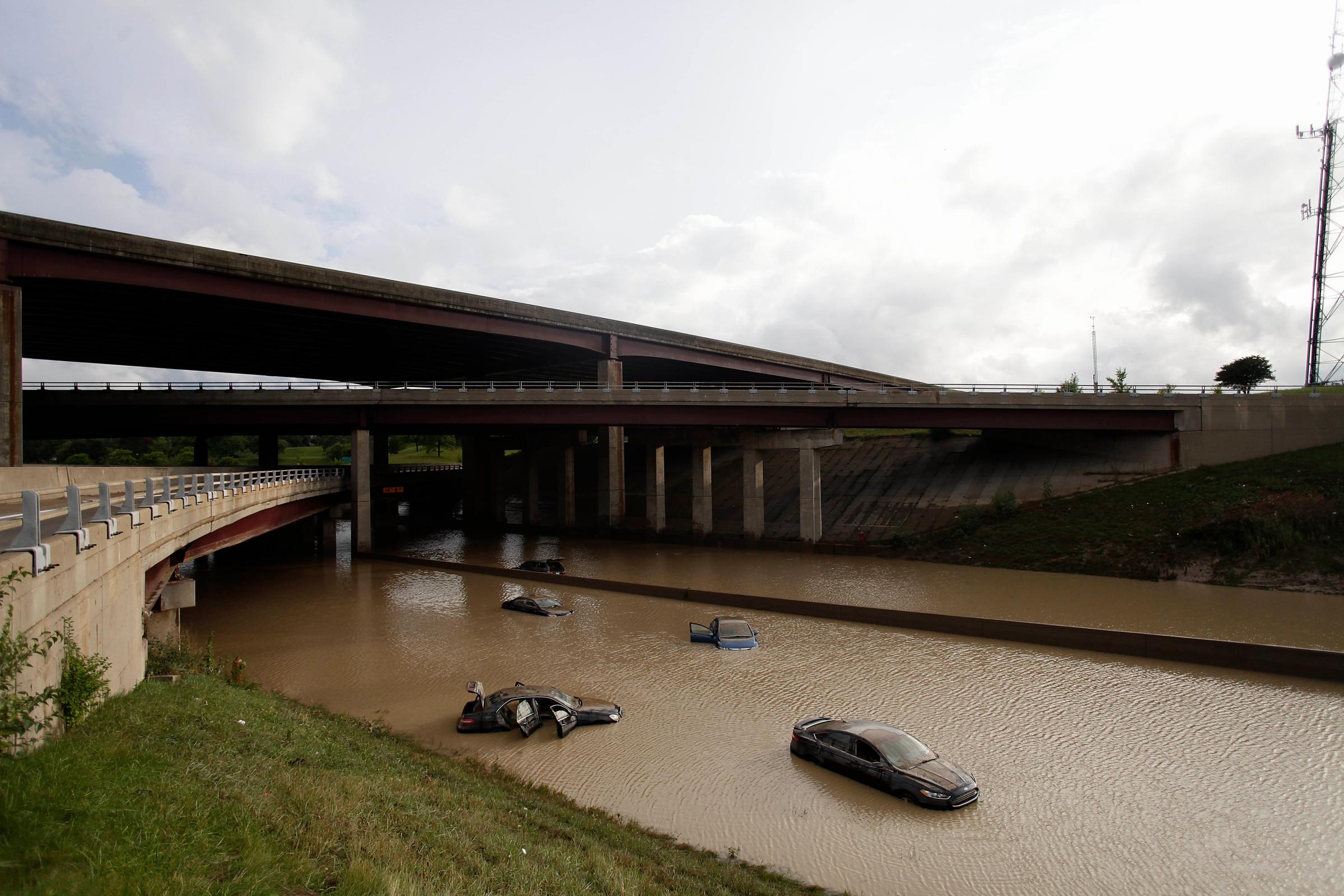Aug.t 12, 2014. Vehicles sit submerged in water along I-75, in Royal Oak, Michigan.