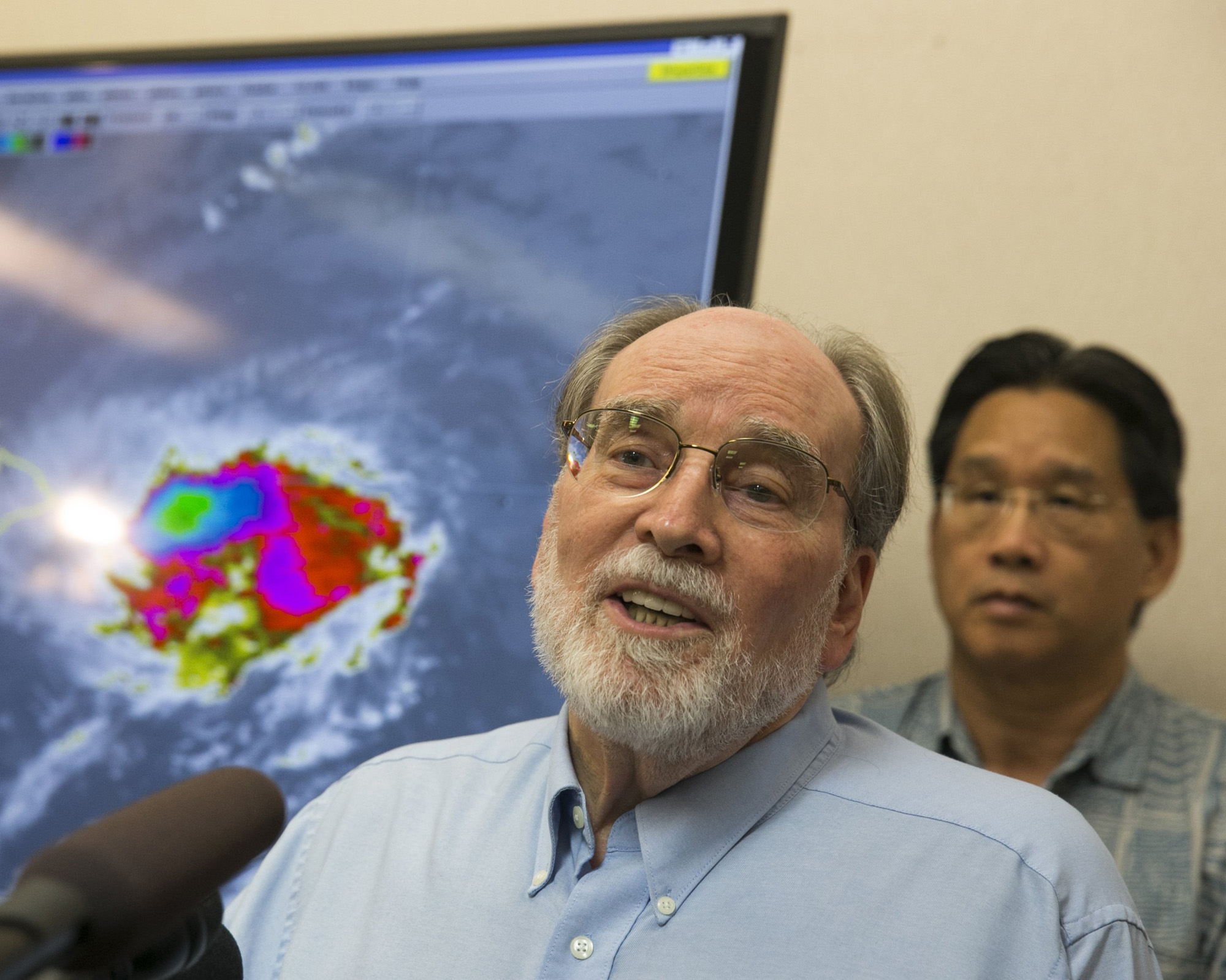 Hawaii Gov. Neil Abercrombie, center, speaks at the National Weather Service office on the campus of the University of Hawaii, Aug. 7, 2014, in Honolulu. (Marco Garcia—AP)