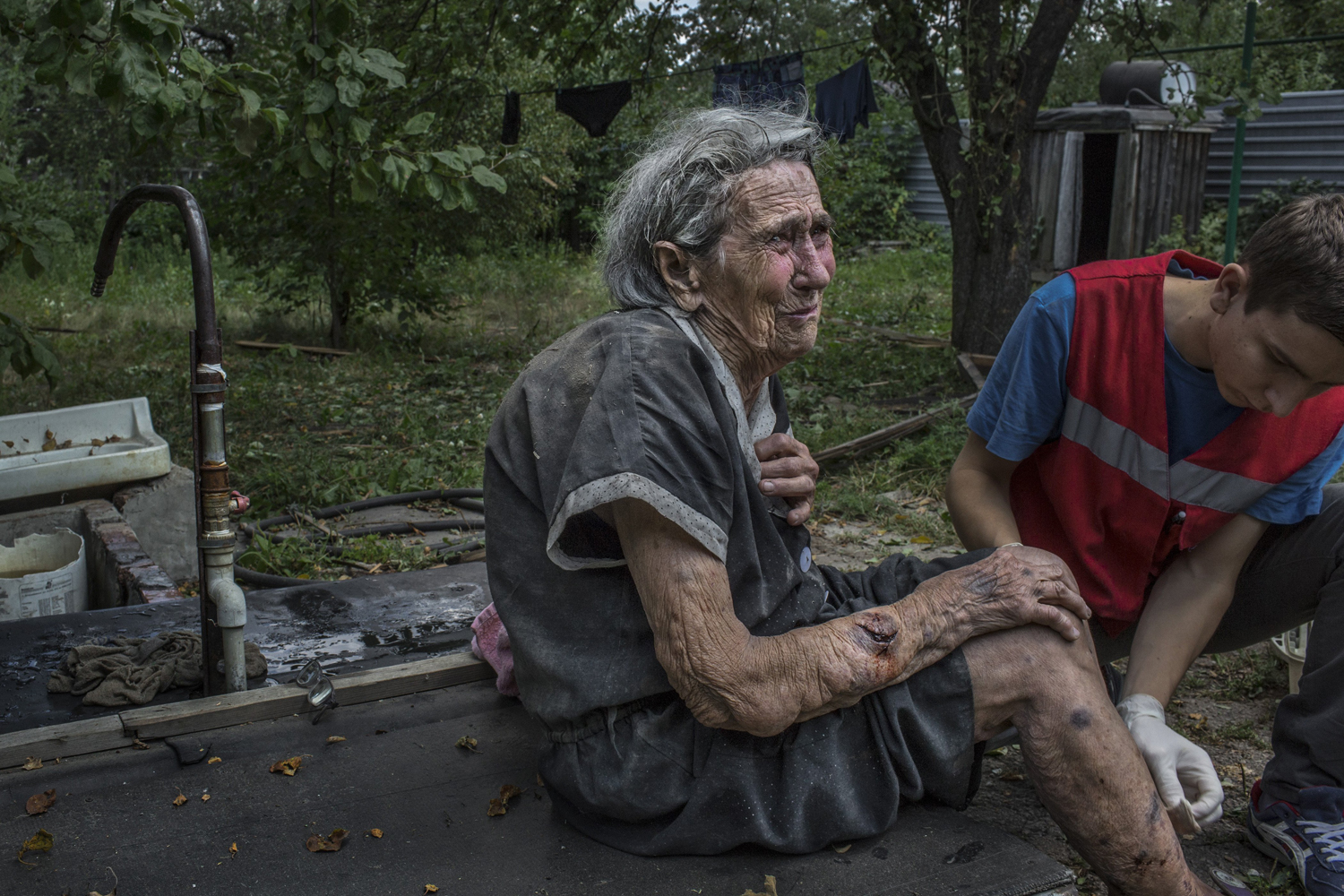 Aug. 10, 2014. Lisa Soroka, 80, who lost a grandson to a rocket attack, is treated for injuries after heavy shelling in the morning near the city's airport, in Donetsk, Ukraine.