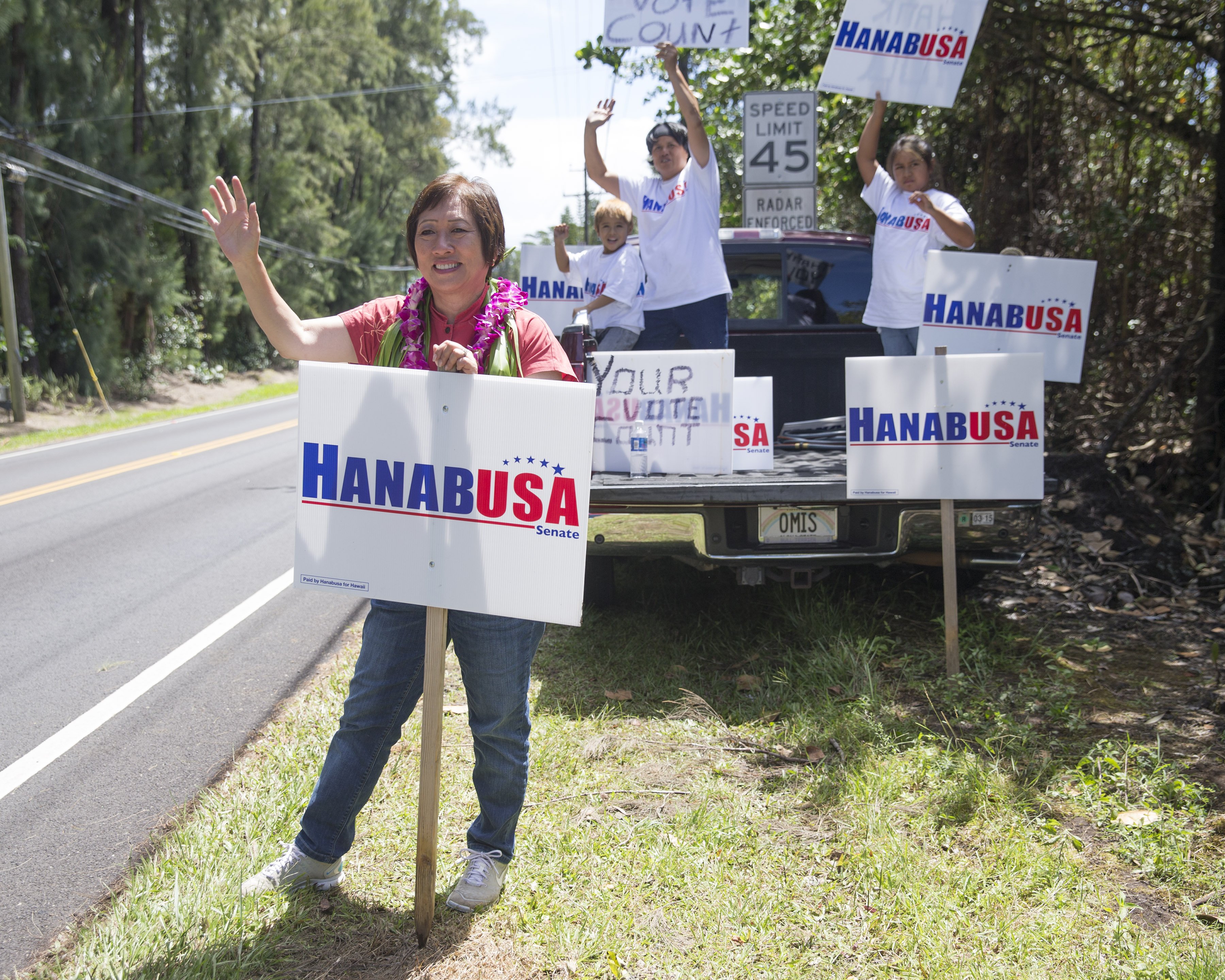 U.S. Rep. Colleen Hanabusa, left, and a group of supporters do some last minute campaigning near the polling place on Aug. 15, 2014, in Pahoa, Hawaii. (Marco Garcia—AP)