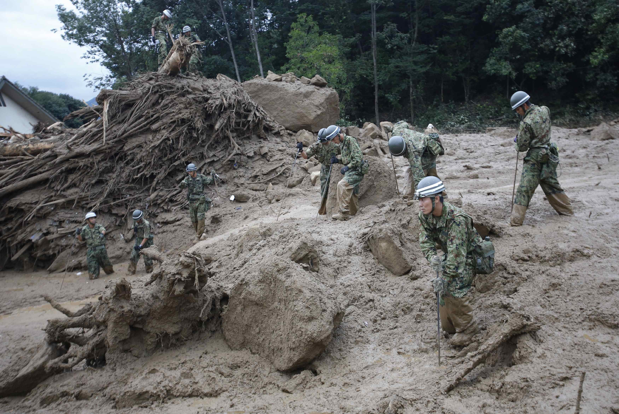 Japan Self-Defense Force soldiers search for survivors at the site of a landslide at Asaminami ward in Hiroshima,  Aug. 20, 2014.