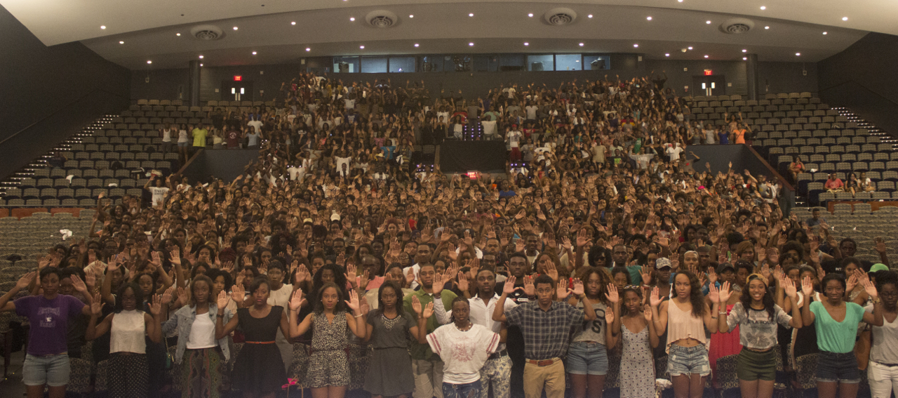 Howard University students pose with their hands raised in Cramton Auditorium in Washington on Aug. 13, 2014. (Howard University)