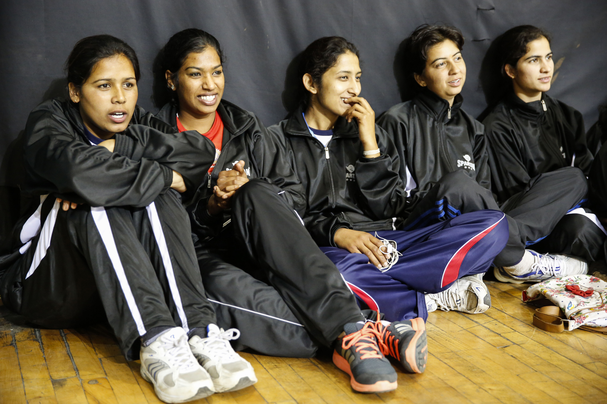 Members of the Rajasthan Women’s team watching the action at the 64th Senior National Basketball Championship for Men and Women, Delhi 2014.