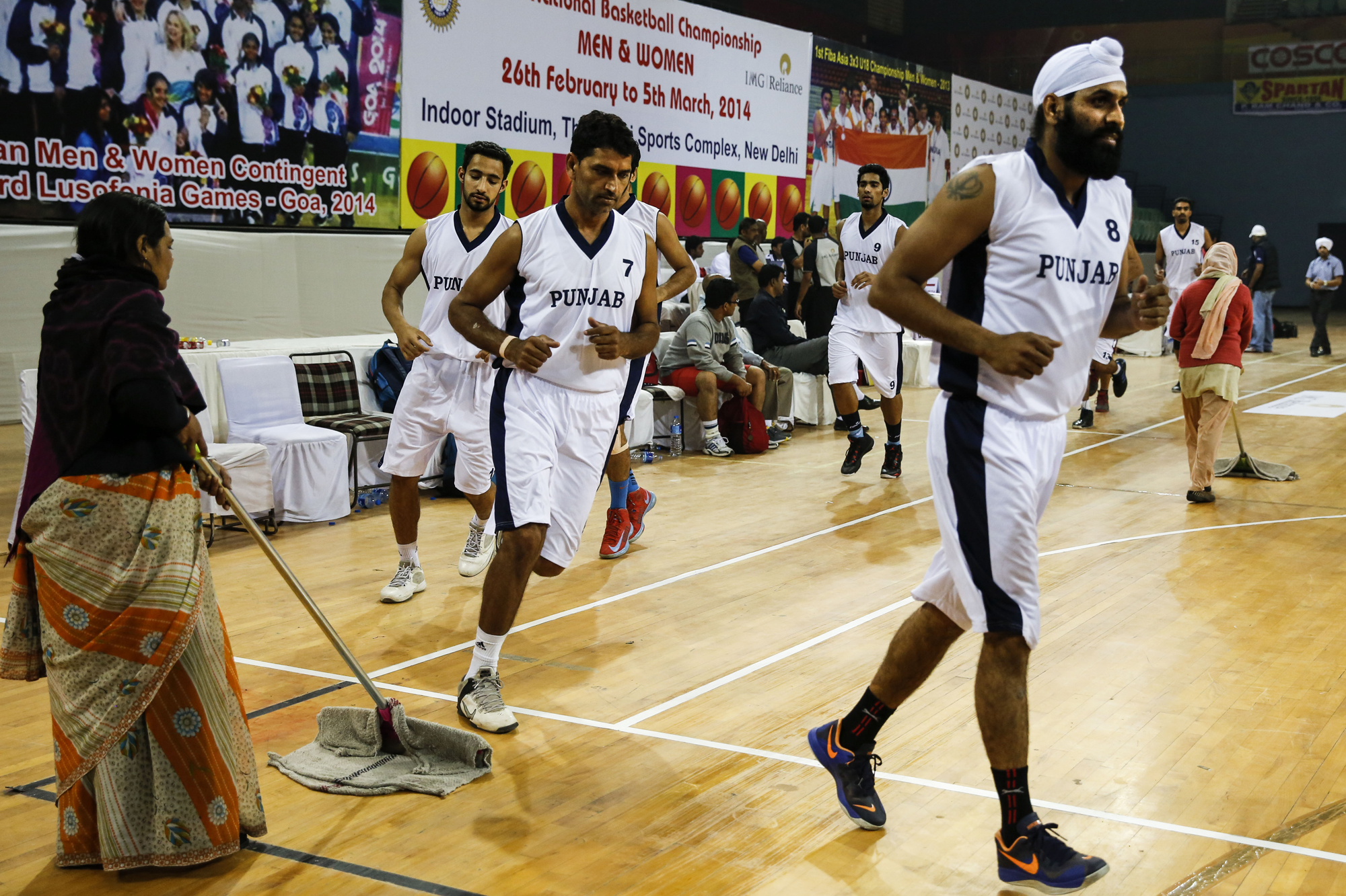 Dhillon Gur leads the Punjab team pre-game warmup up 64th Senior National Basketball Championship for Men and Women, Delhi 2014