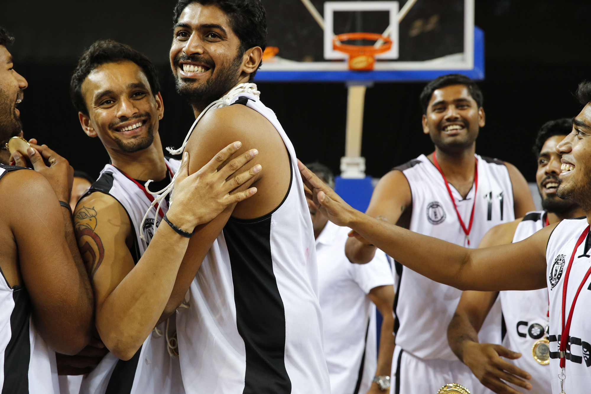 Pratham Singh, Riken Pethani, Akilan Pari and members of the Tamil Nadu team celebrate their victory at the 64th Senior National Basketball Championship, Delhi, 2014.