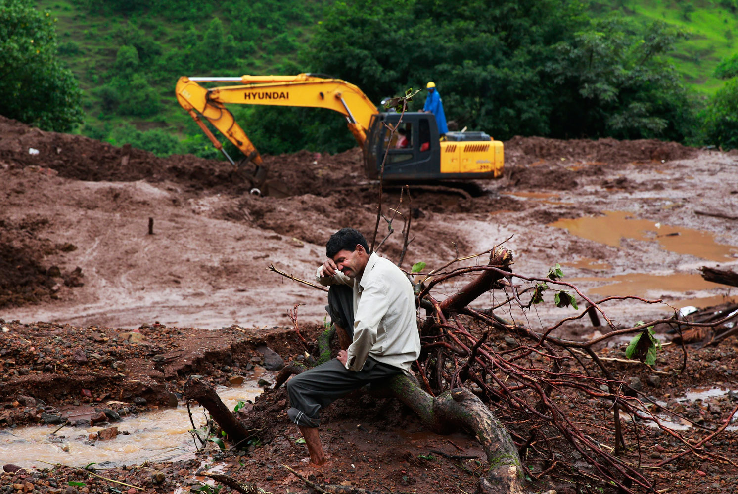 Chandrakant Zanjare, who said he lost 13 family members to a landslide, wails near the site where his house stood in Malin village, in the western Indian state of Maharashtra on Aug. 1, 2014.