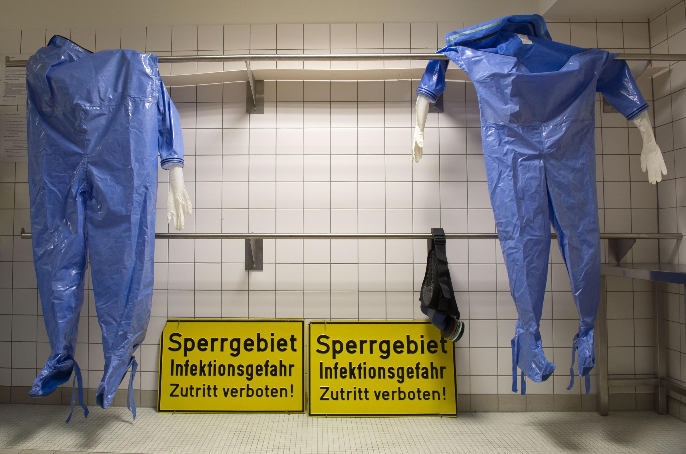 Protective clothing hangs in a changing room of the quarantine office of Berlin's Charite hospital on August 11, 2014.