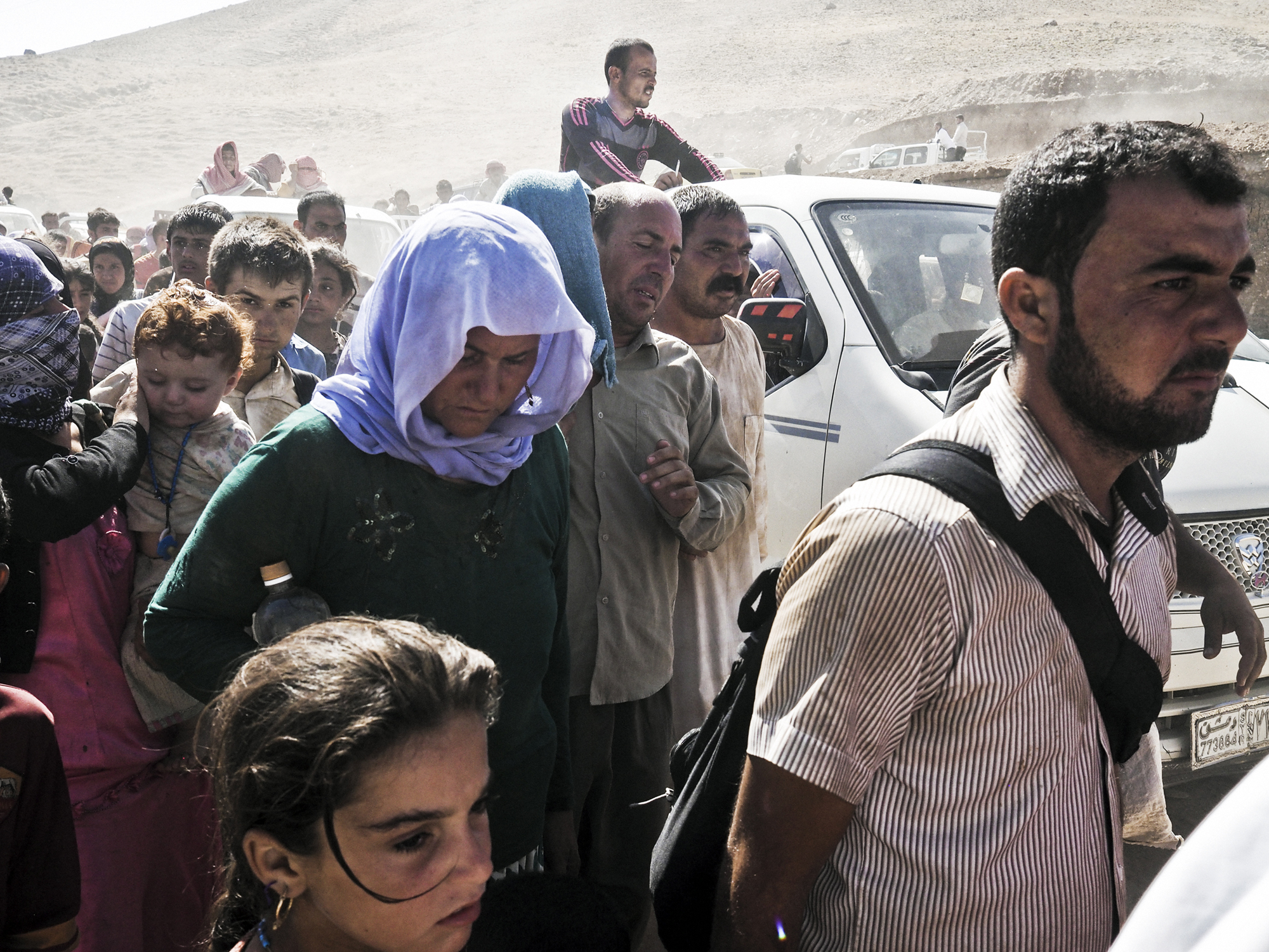 Yazidi families from Sinjar arrive at the Fishkhabur border crossing between Iraq's Dohuk Province and Syria, Aug. 10, 2014. (Moises Saman—Magnum for TIME)
