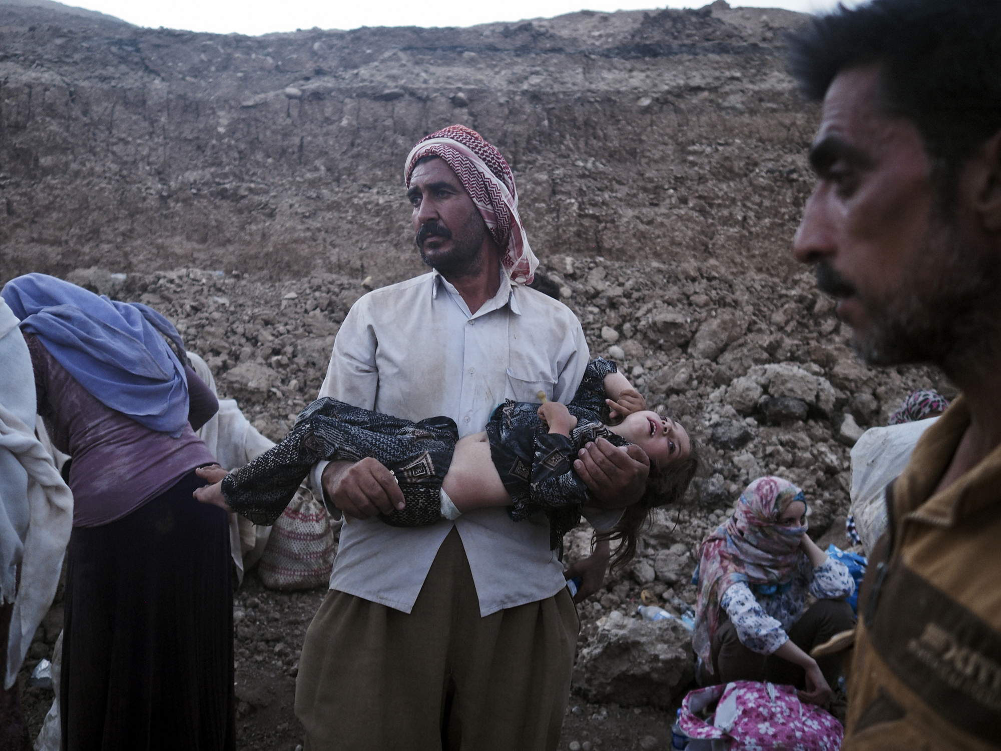 A Yazidi family from Sinjar arrive at the Fishkhabur border crossing between Iraq's Dohuk Province and Syria, Aug. 10, 2014.