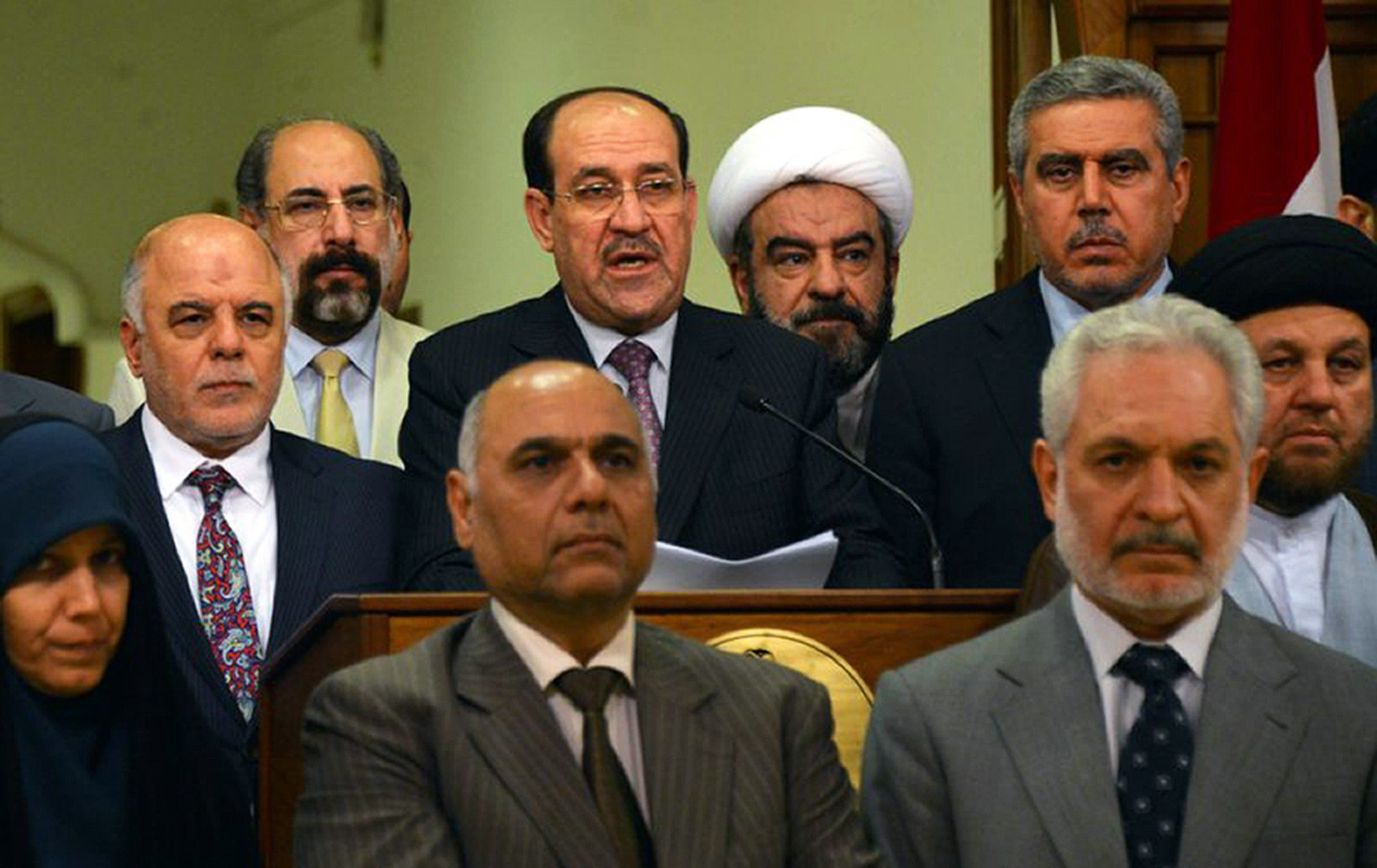 Outgoing Iraqi prime minister Nuri al-Maliki, alongside his designated successor Haidar al-Abadi, delivering a speech in which he announced withdrawing his candidacy for a third term in a photo released Aug. 14, 2014,