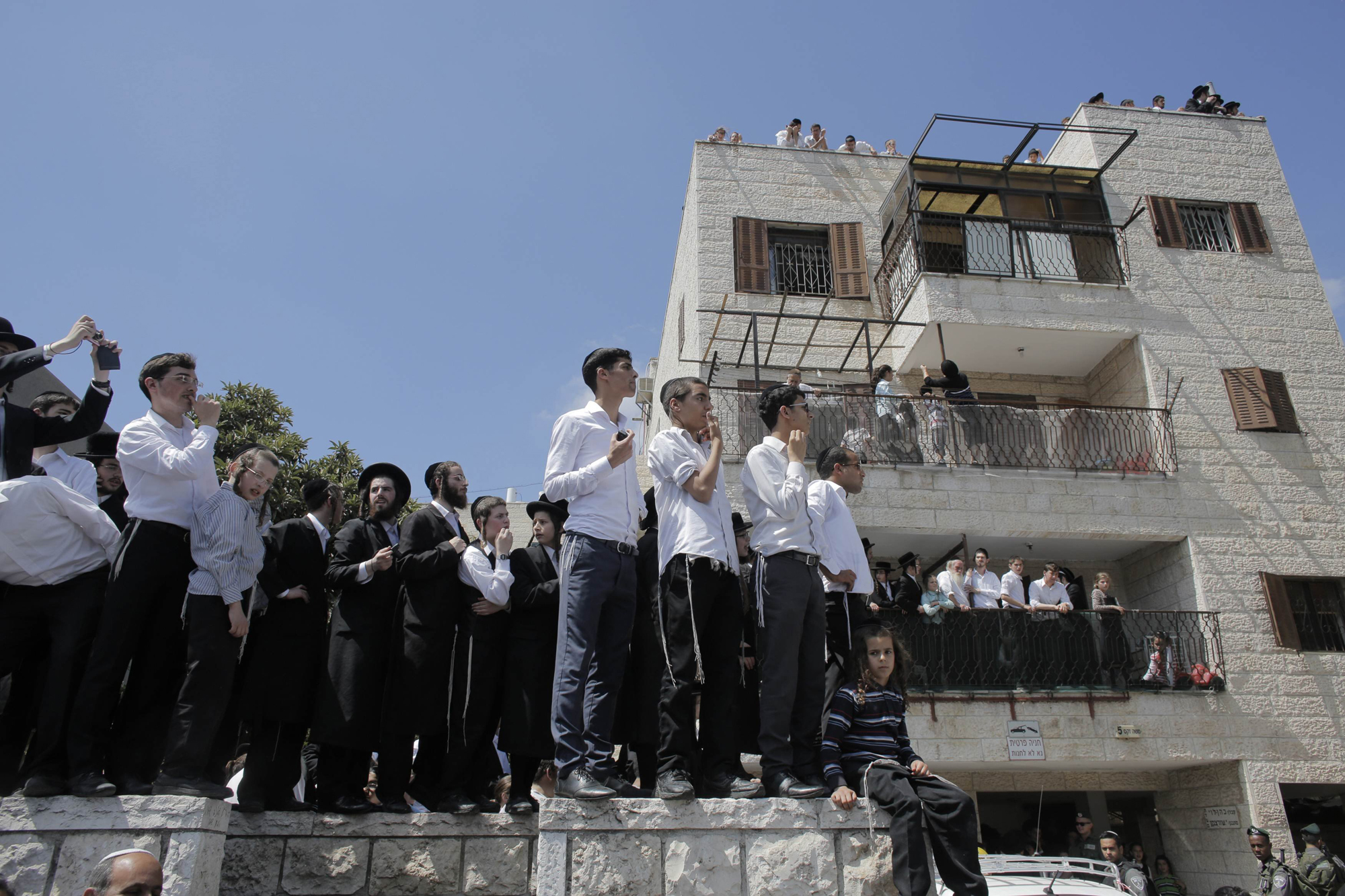 Residents gather at the scene of a suspected attack in Jerusalem, Aug. 4, 2014.