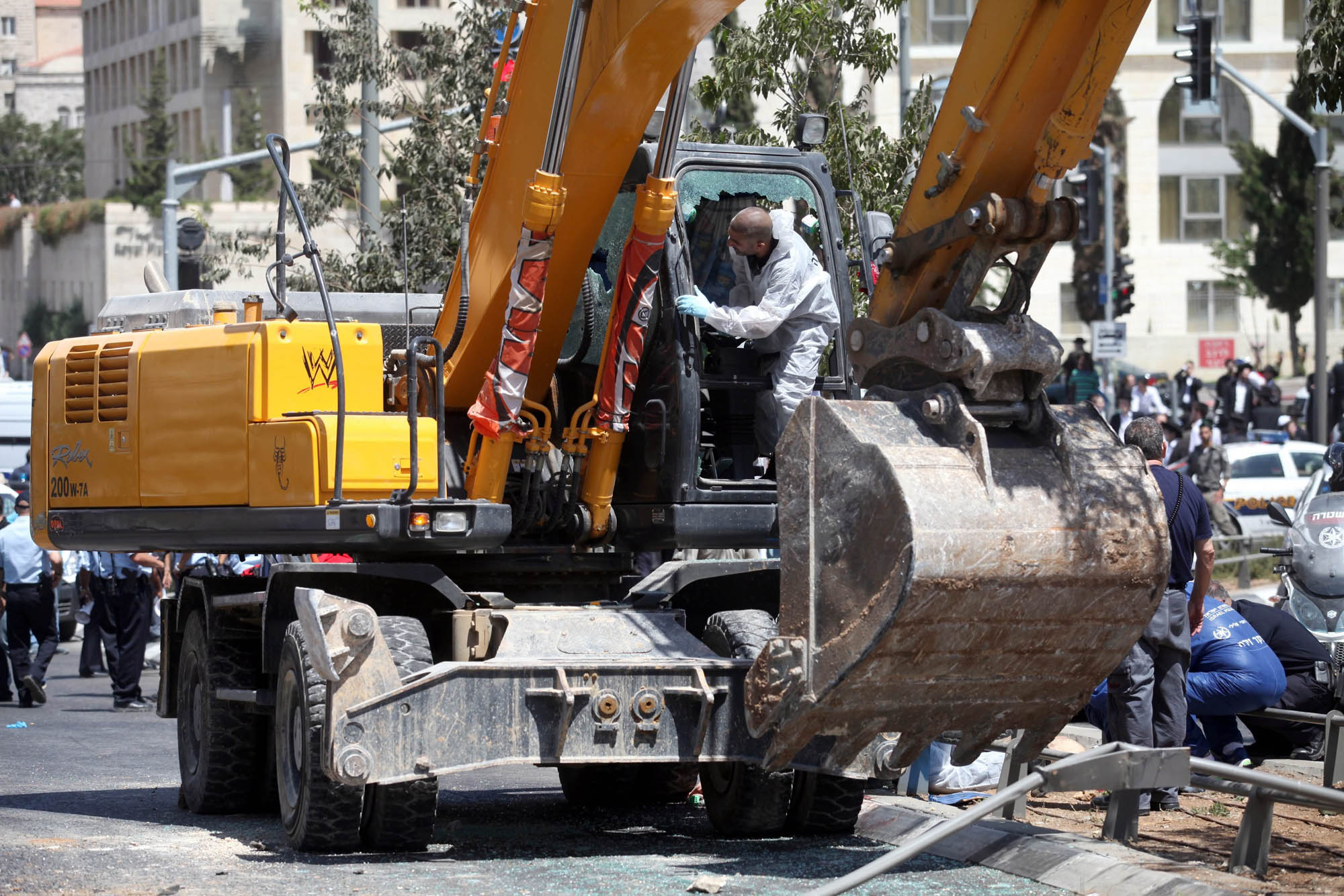Israeli forensic police inspect the bulldozer at the scene of attack in Jerusalem, Aug. 4, 2014.