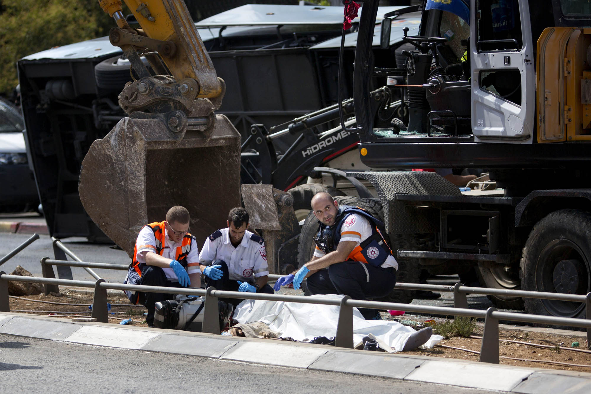 Israeli medics inspect a body at the scene of an attack in Jerusalem, Aug. 4, 2014.