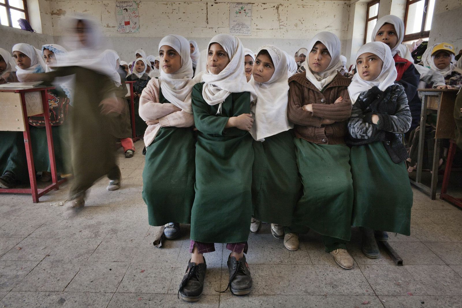 Yemeni students sit on a bench at a class in a public school in Sanaa, Yemen, Dec. 2012.