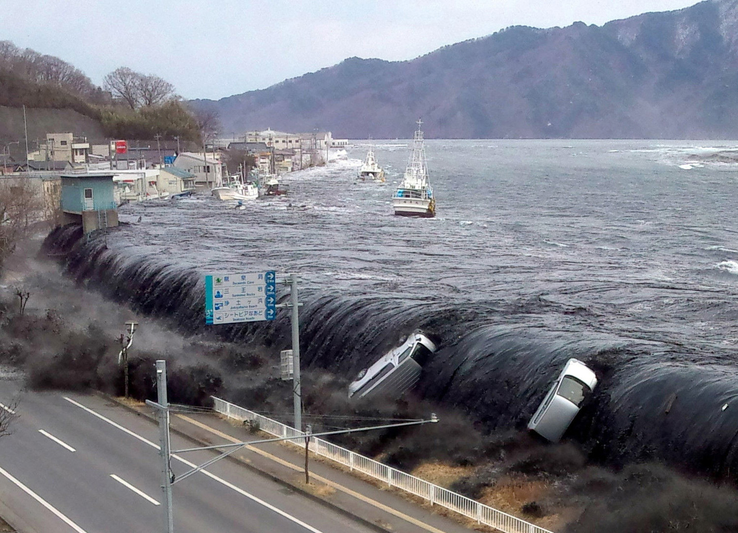 Picture taken by a Miyako City official shows a tsunami breeching an embankment and flowing into the city of Miyako in Iwate prefecture shortly after a 9.0 magnitude earthquake hit the region of northern Japan. March 11, 2011.